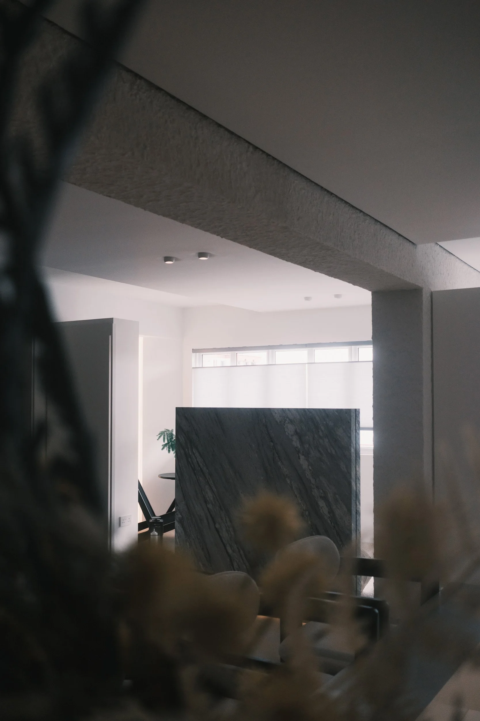 Honeycomb blinds in a Singapore HDB home, partially covering the windows to provide privacy while still allowing soft sunlight to enter.