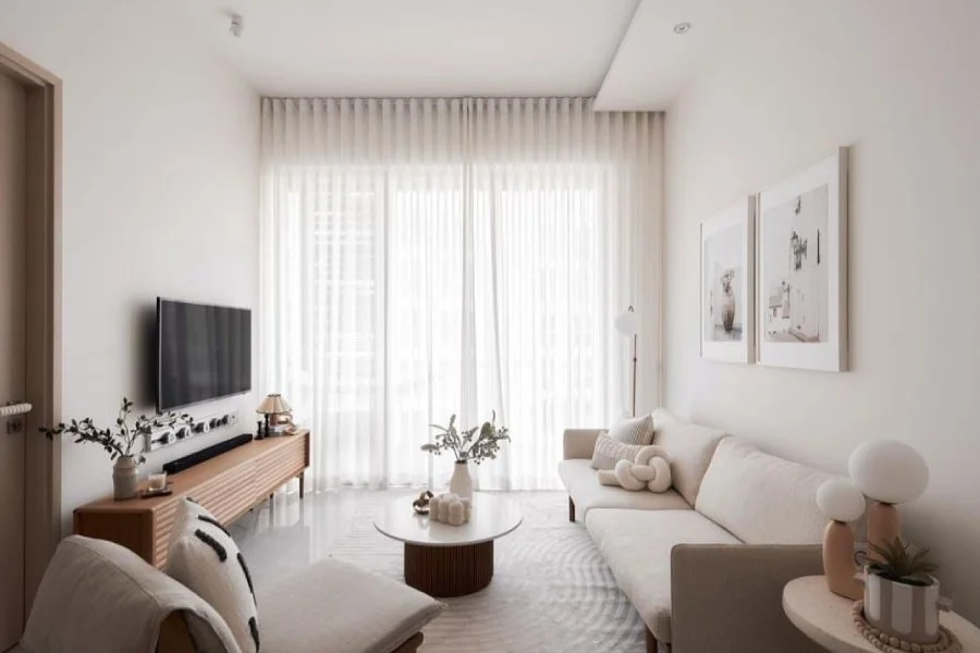 Curtains Singapore sheer curtains in a bright minimalist living room with white sofa, TV console, coffee table, and soft natural light.