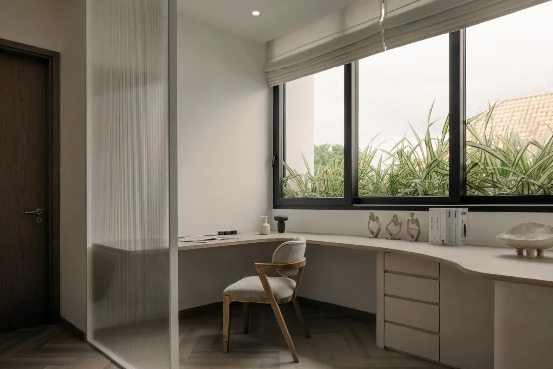 Roman blinds in a calm Singapore study corner, offering privacy and light control beside a curved desk and greenery outside the window.