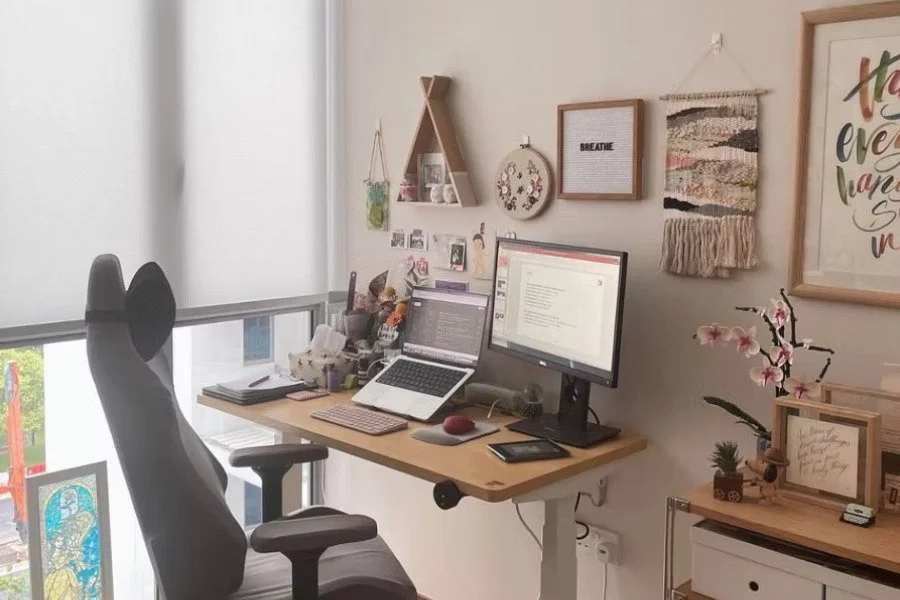 Curtains Singapore roller blinds in a home office with work desk, monitor, laptop, office chair, and soft filtered daylight.
