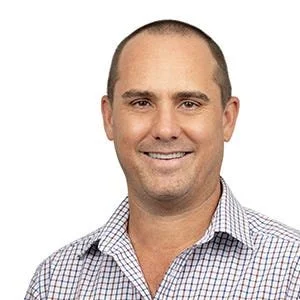 A smiling man with short hair and wearing a checkered button-up shirt. Nigel Sharp from NTC Property