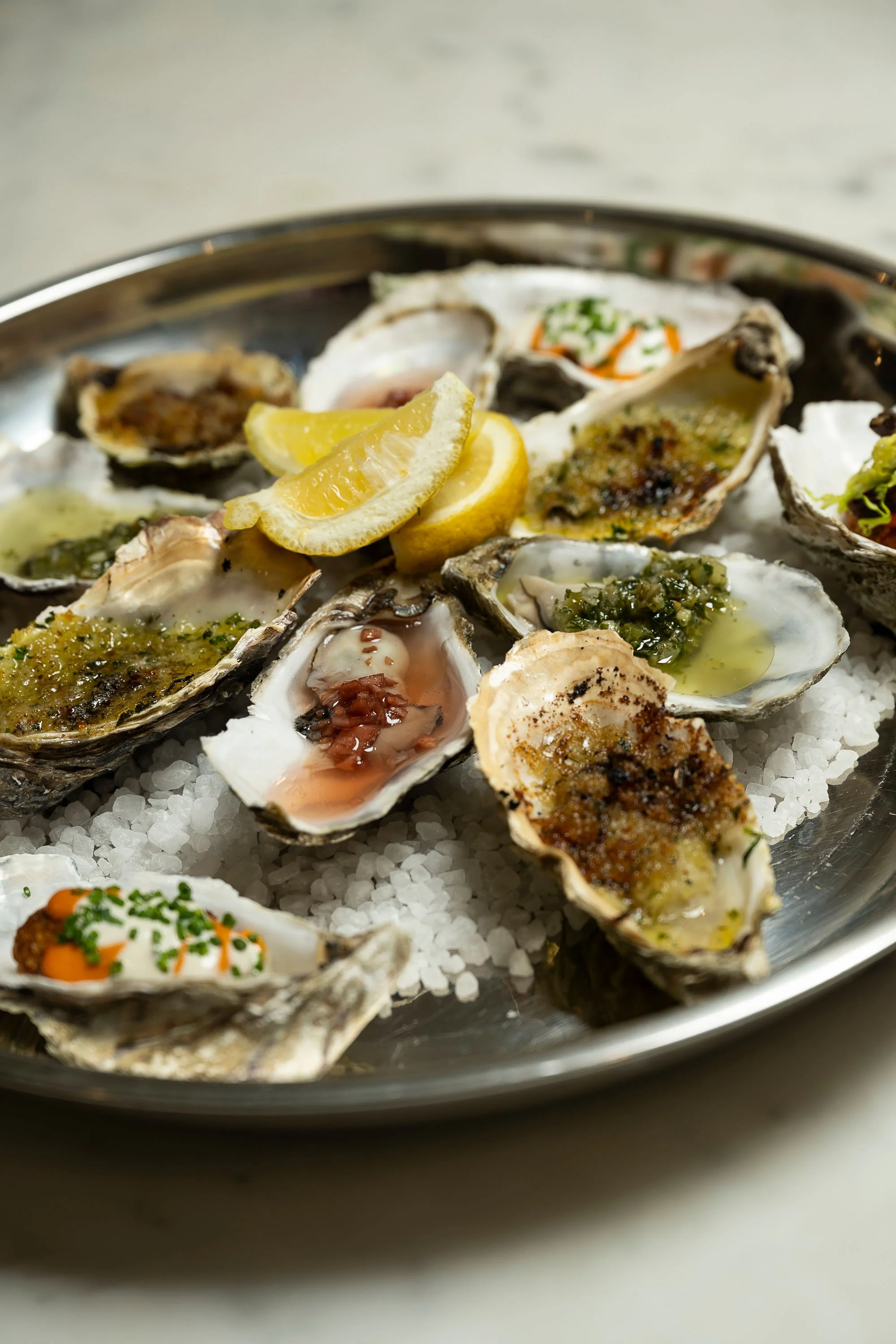 Fresh oysters served with lemon wedges.