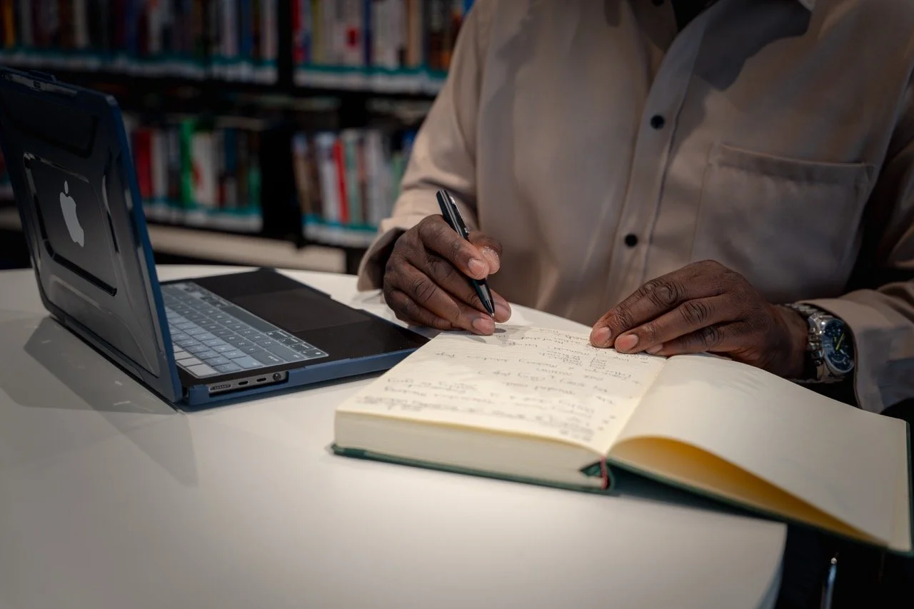Man while writing in his notebook.