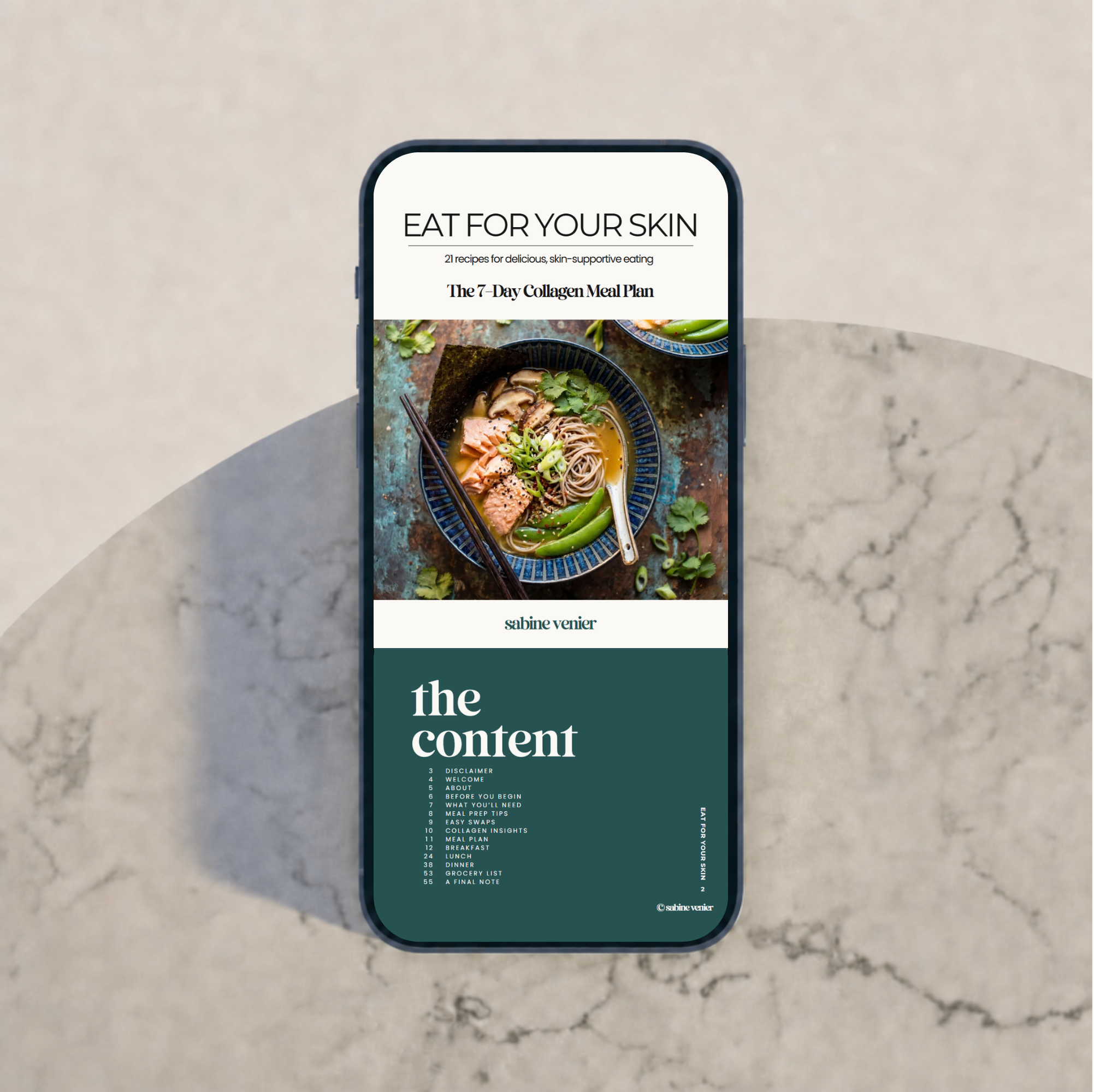 Mobile phone displaying a meal plan titled "Eat for Your Skin" with a picture of a bowl of Asian-style noodles with vegetables and salmon, and a menu with sections such as "Disclaimer," "Welcome," "About," and "Meal Plan" on a concrete surface.