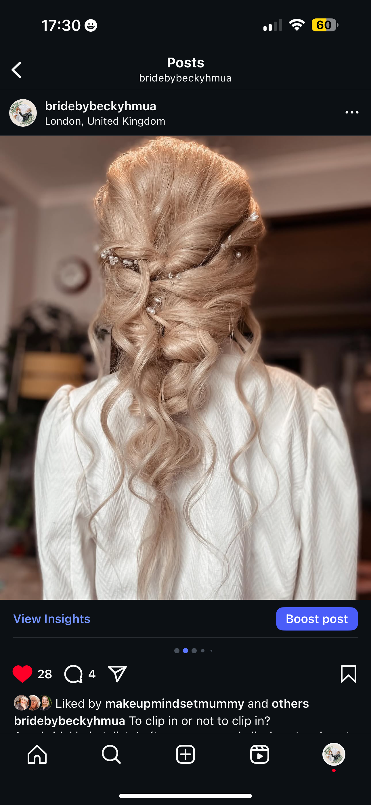 Back view of a woman with long, blonde, curled hair styled with pearl and bead hair accessories