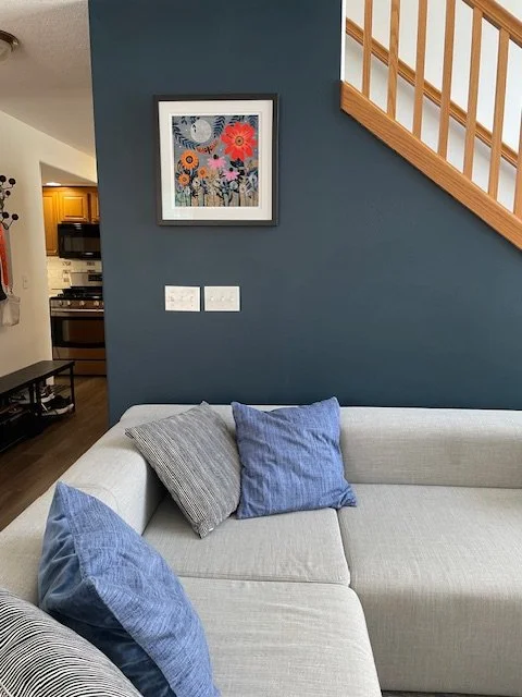 Living room with coach and piece of art