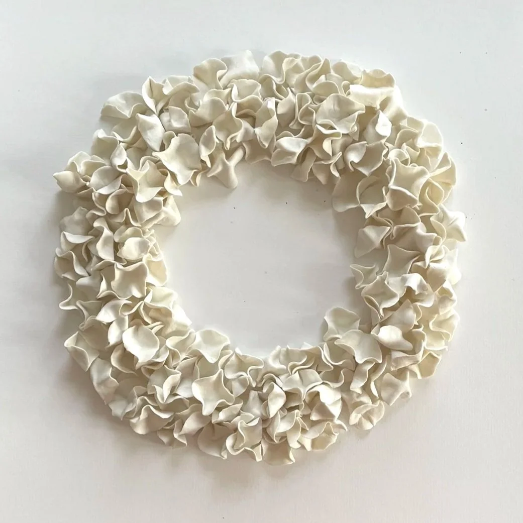 White floral wreath on a white background.