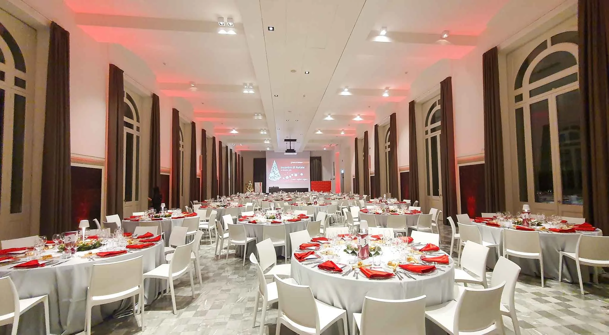 Sala da pranzo elegantemente arredata per un evento natalizio, decorazioni natalizie e illuminazione calda.