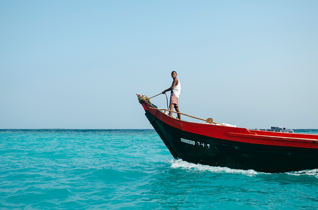 Photo of fisherman on a small boat by Miguel Angel Avila on Unsplash