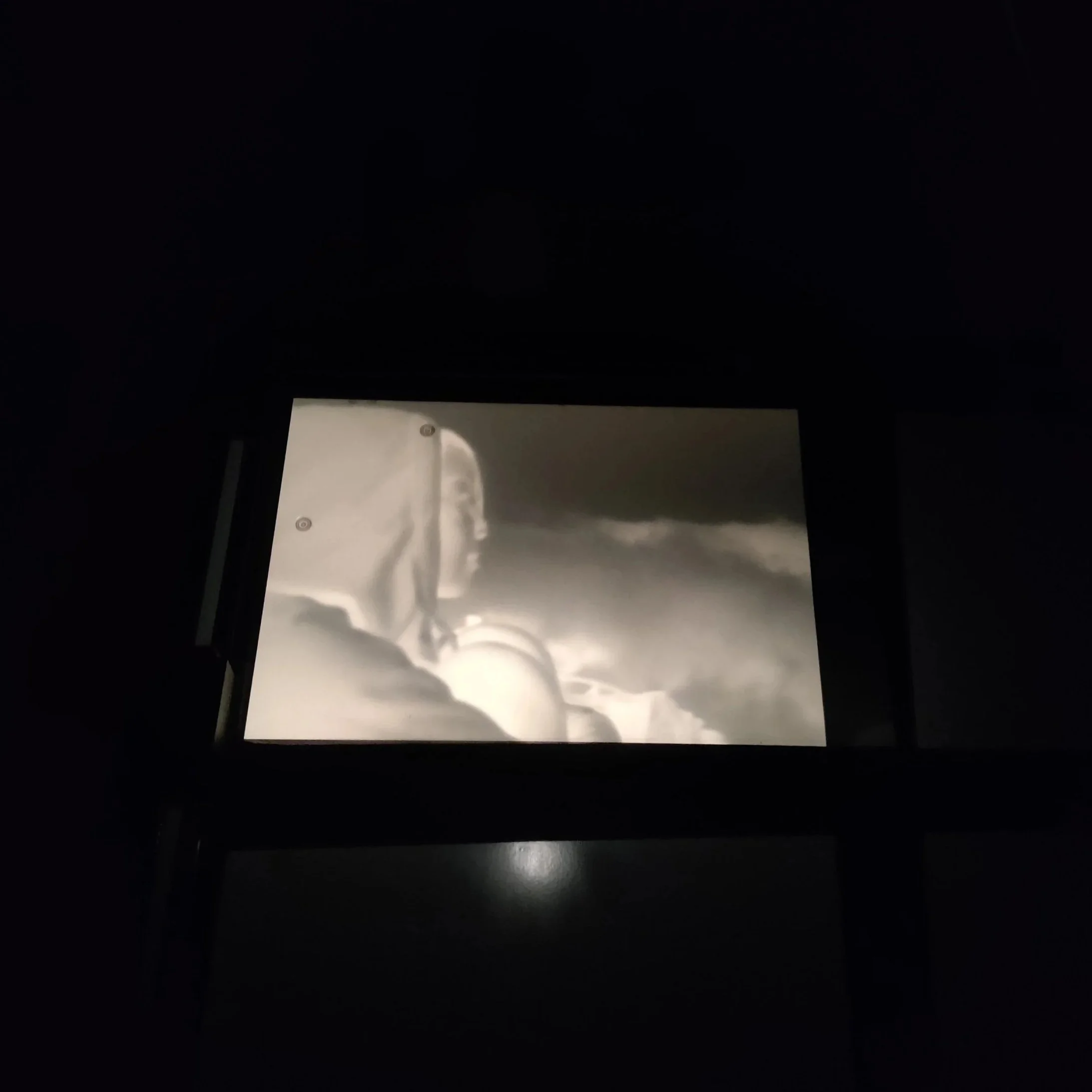 Projection of a black and white film negative using an enlarger.