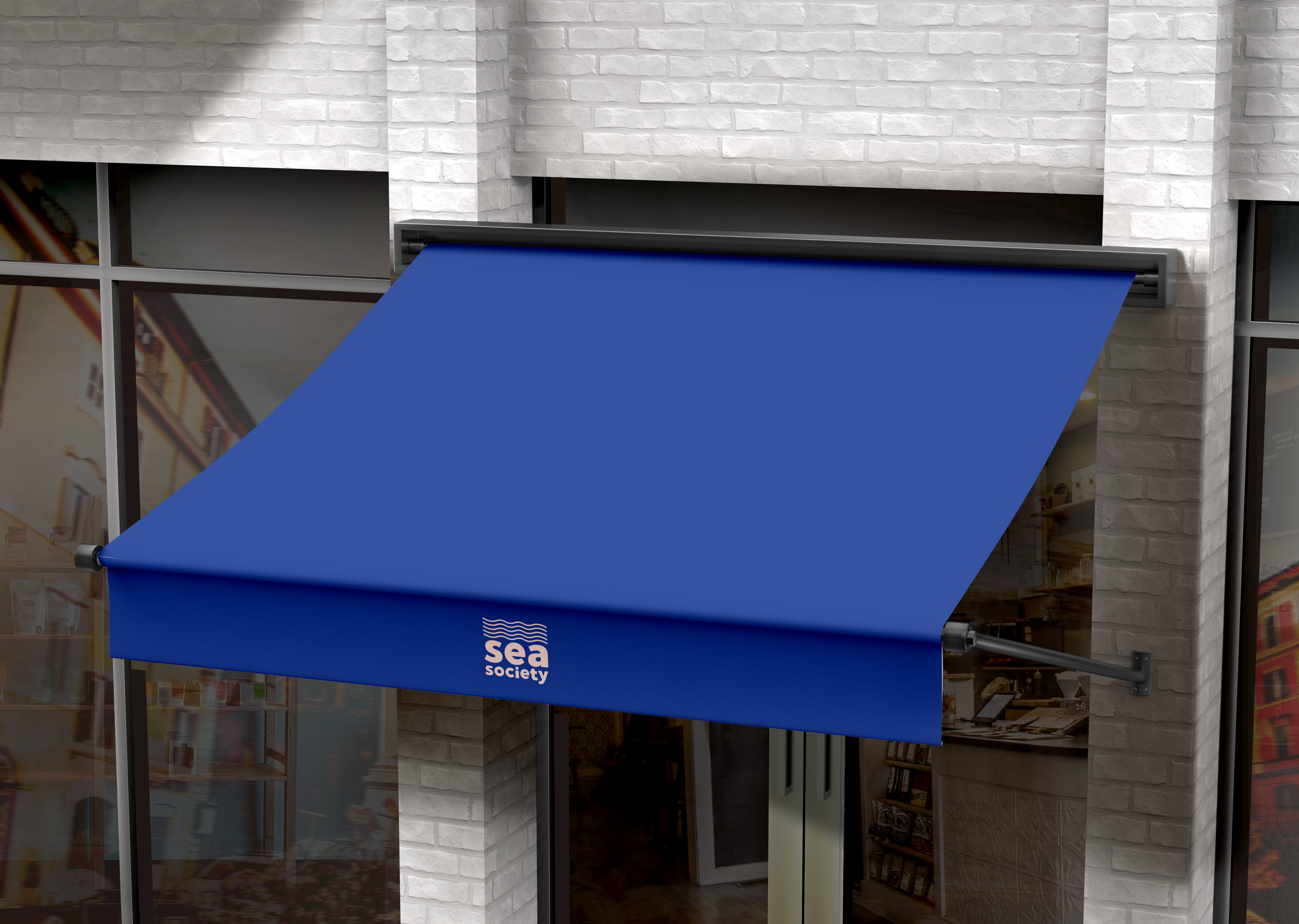 Toldo azul con logo de 'Sea Society' en un edificio con paredes de ladrillo blanco y ventanas de vidrio.