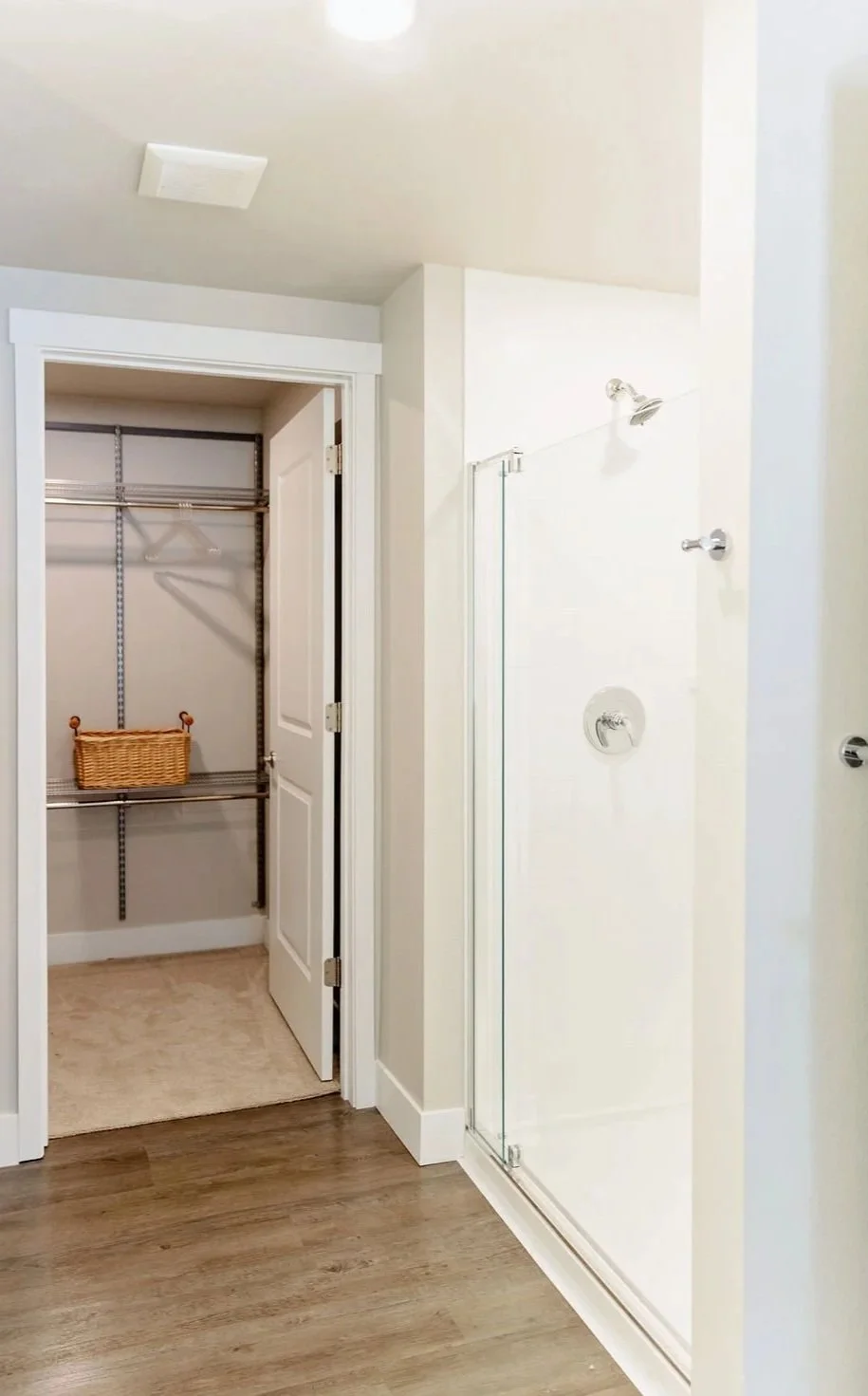 Walk in closet and shower in one bedroom condo.