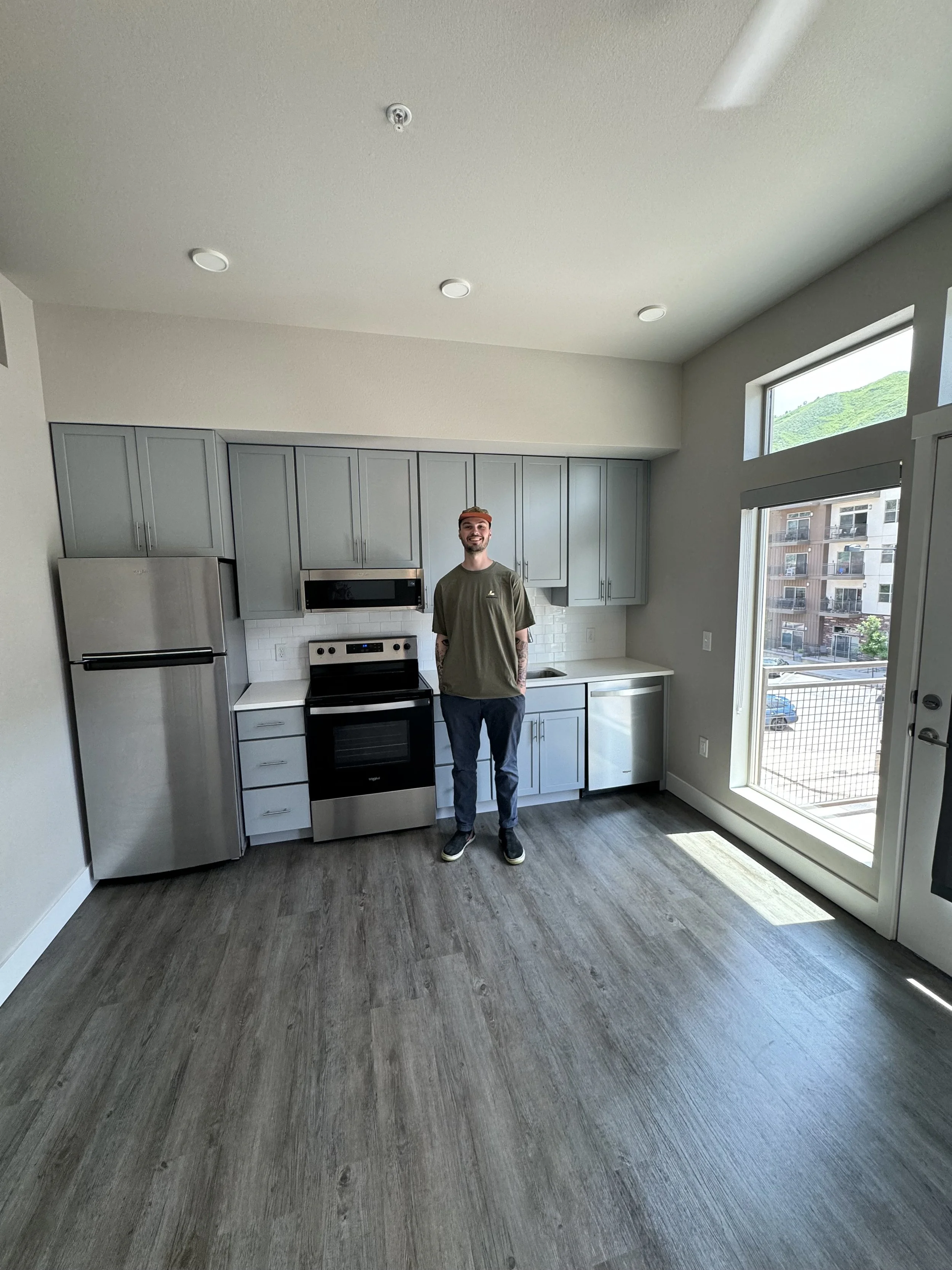 Homeowner, Tanner, standing in his kitchen.