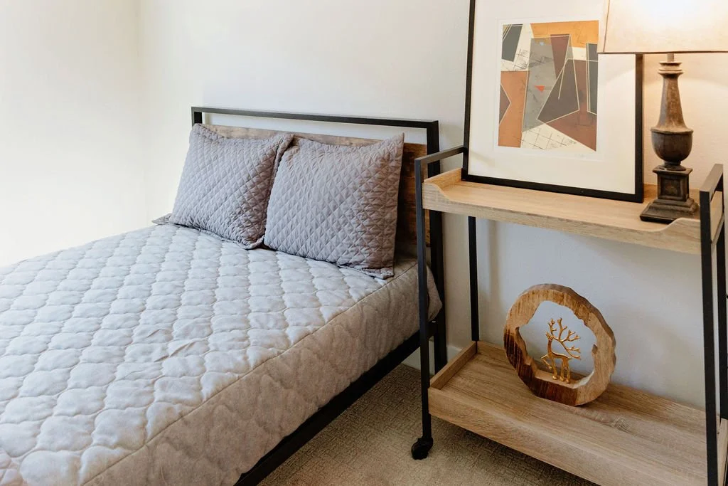 Side table and art work in bedroom.