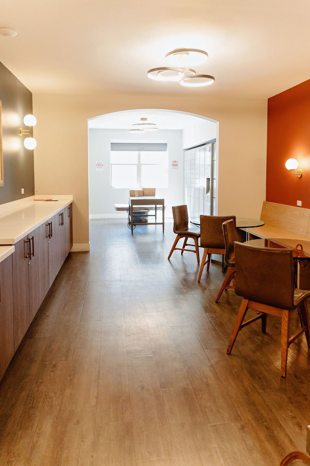 Cafe space with tables, chairs, and bench.
