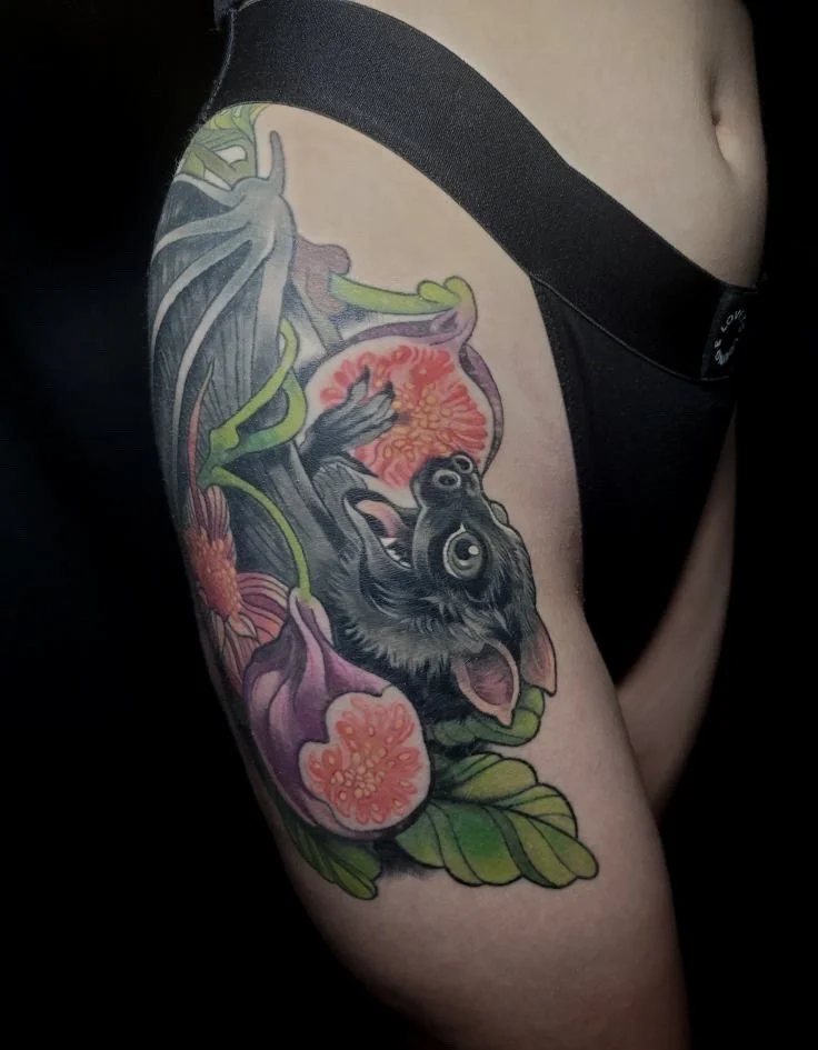 Close-up of a tattoo on a person's thigh featuring a gorilla with multiple eyes, surrounded by purple flowers and green leaves.