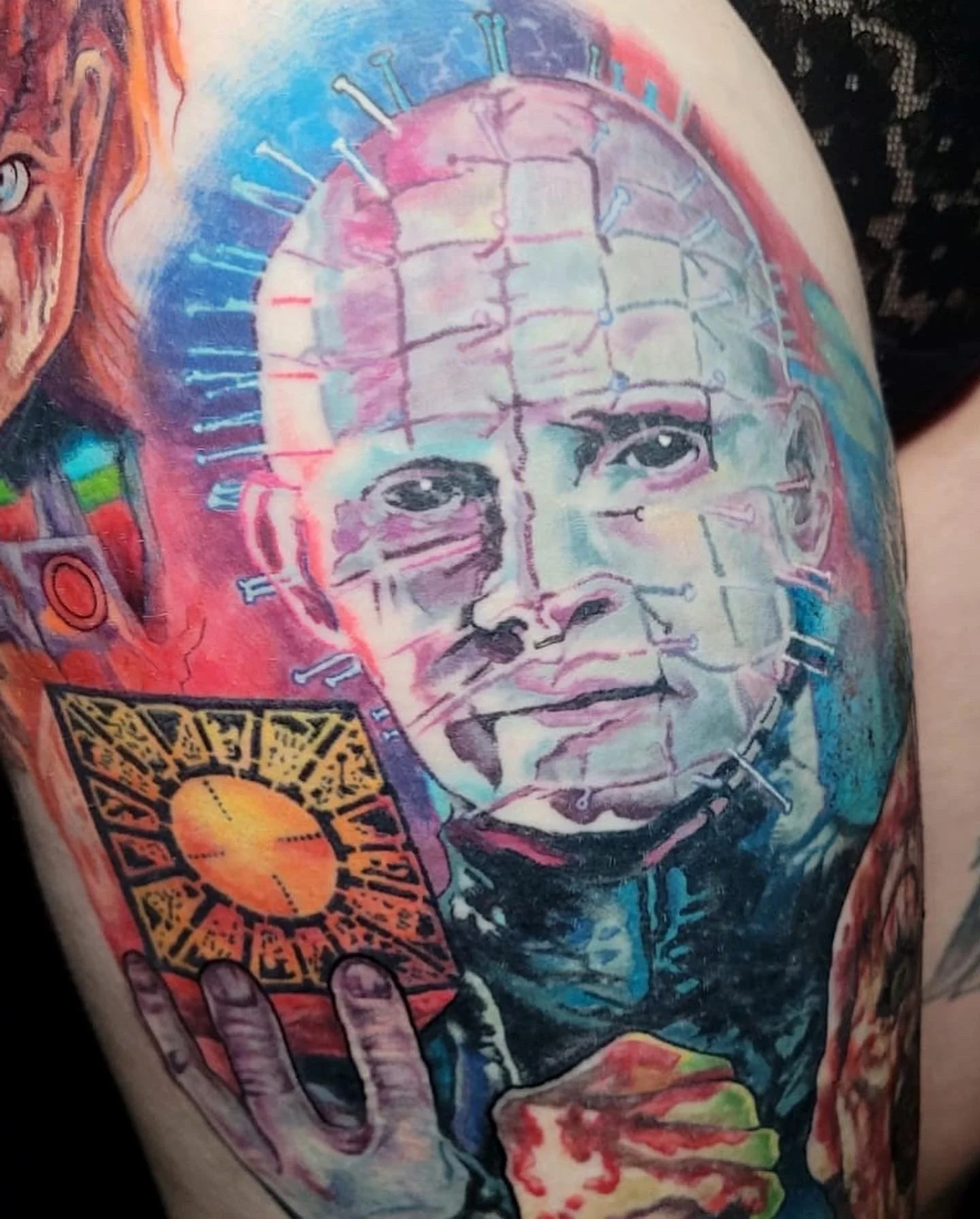 Colorful tattoo of a child with robotic lines on their face, holding a yellow and black object, with vibrant artistic details.