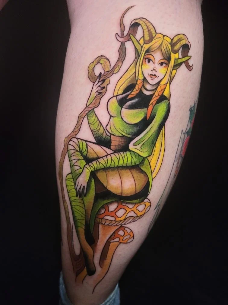 Tattoo of a woman with snake features, fox tail, sitting on a mushroom, with snake hair, on a person's arm.