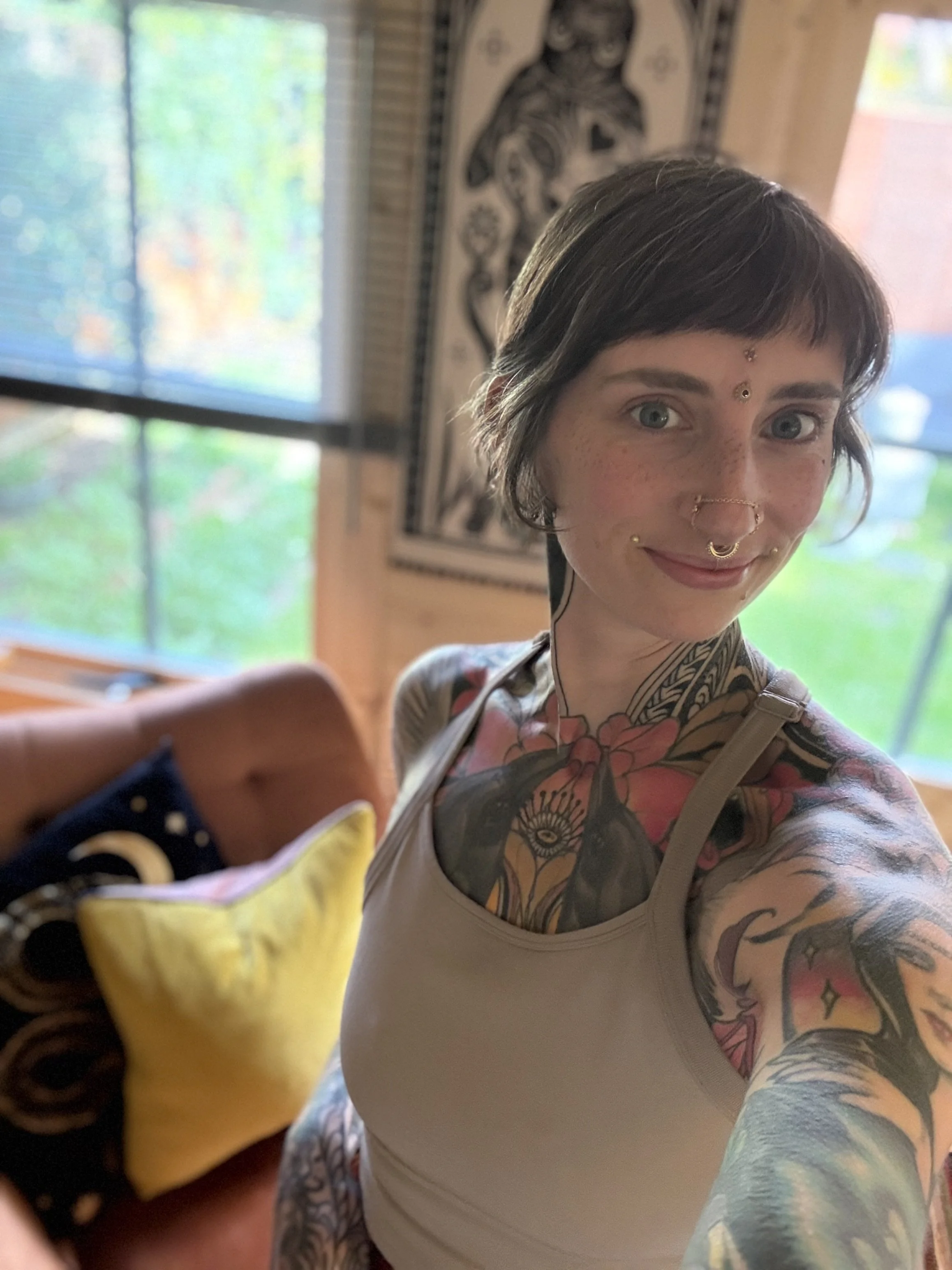 Tattooed woman in front of nature tattoo studio