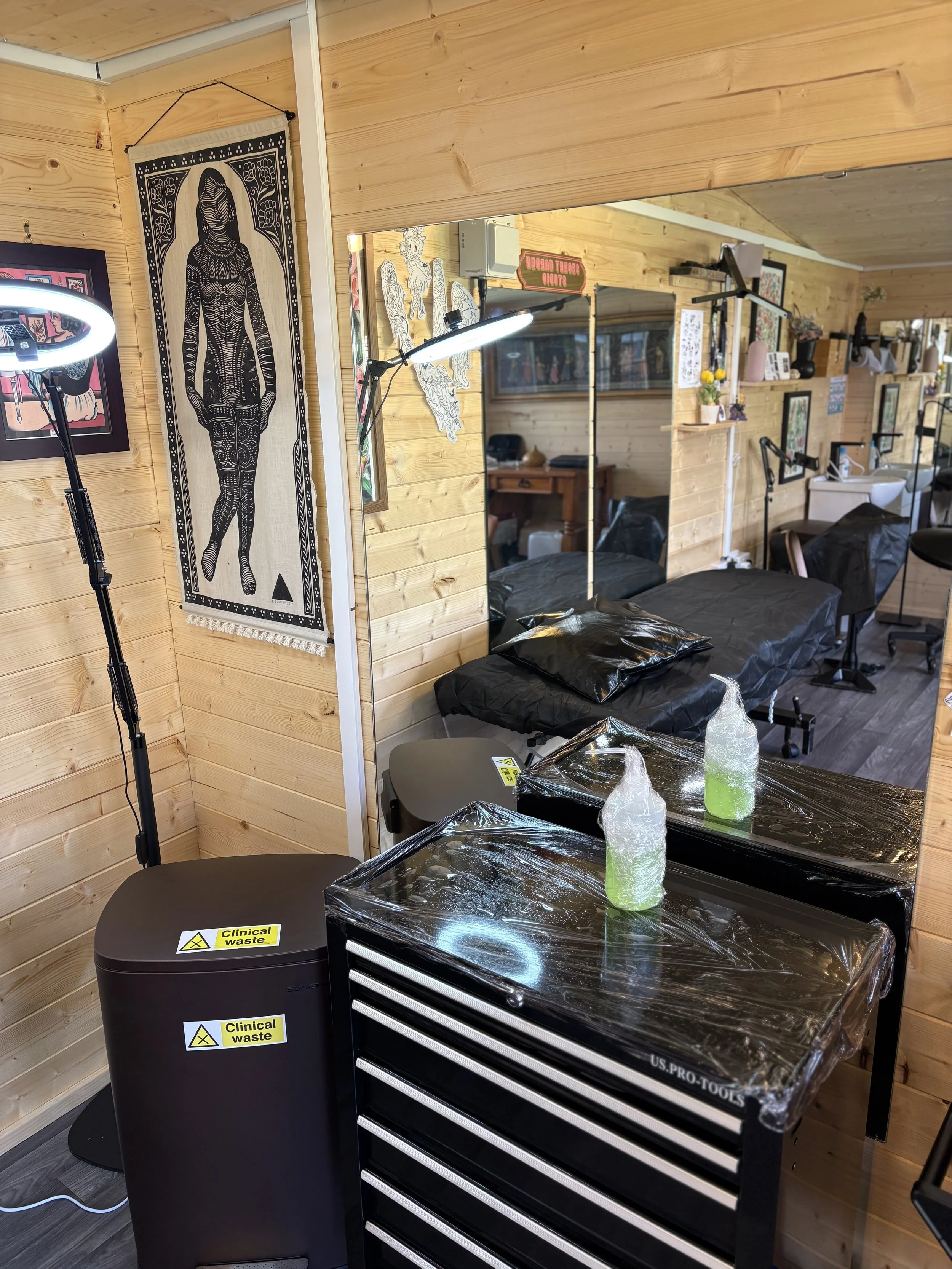 Clean tattoo station prepped sanitary wrapped cling film and mirrors