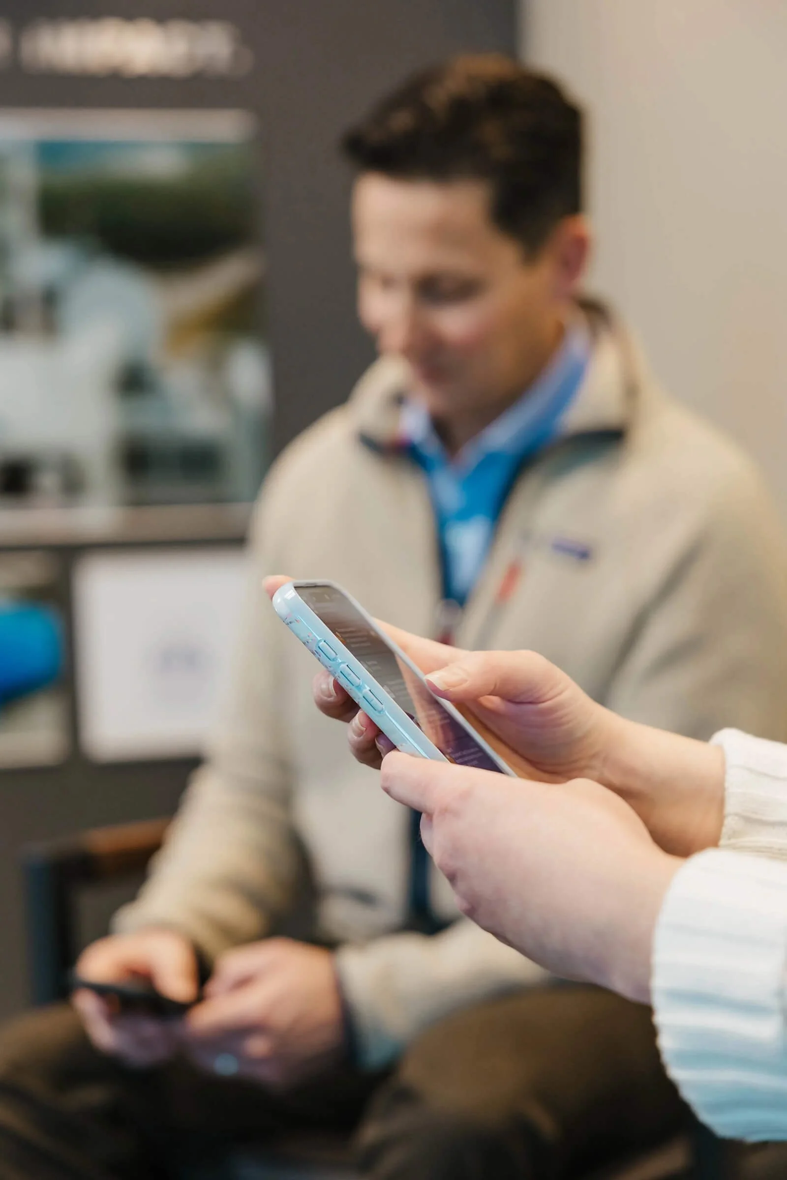 Wisconsin River Partners team member using a smartphone to communicate with a partner or client.