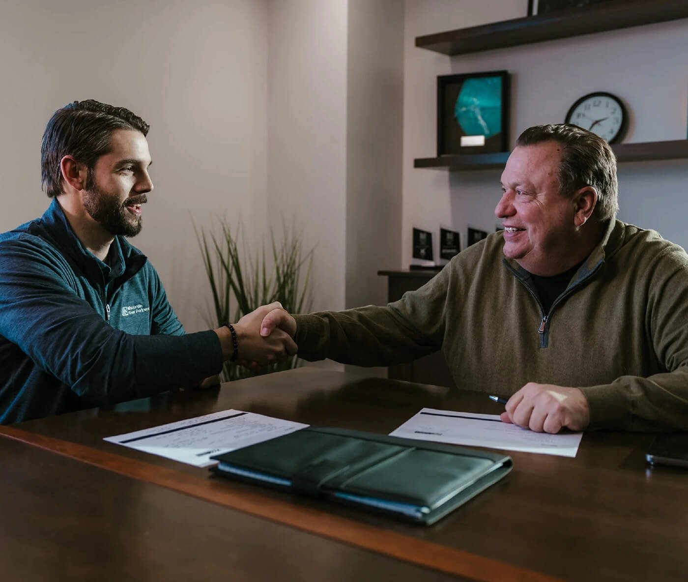 Business owner shaking hands with Jim Frings at the Wisconsin River Partners office in Wausau, WI.