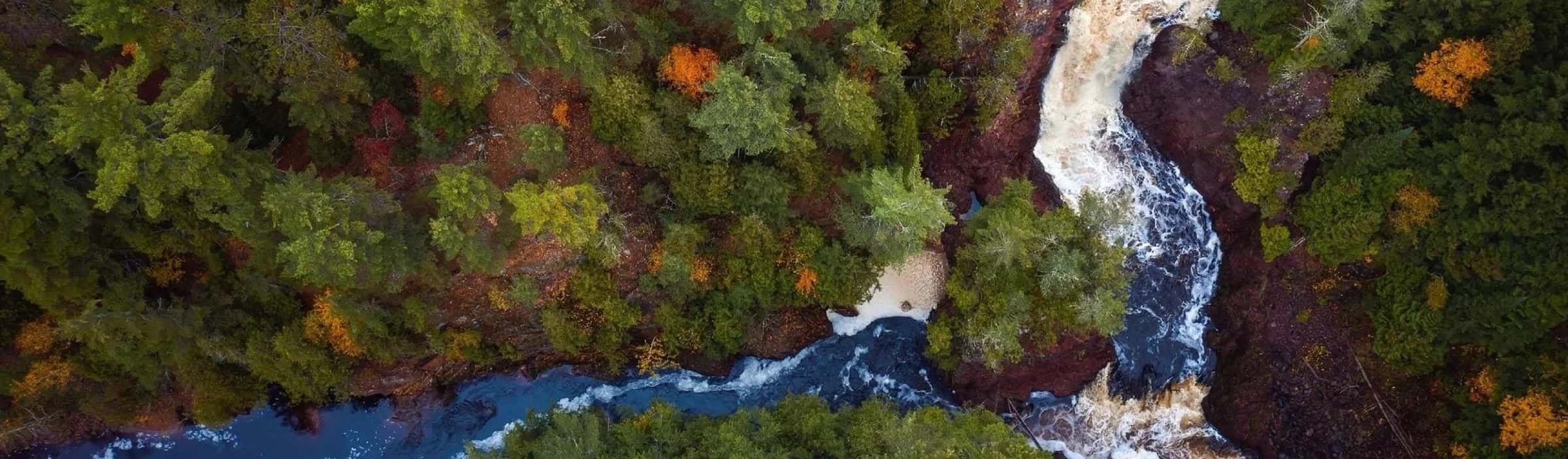 Aerial view of the Wisconsin River flowing through forest landscape in Wisconsin.