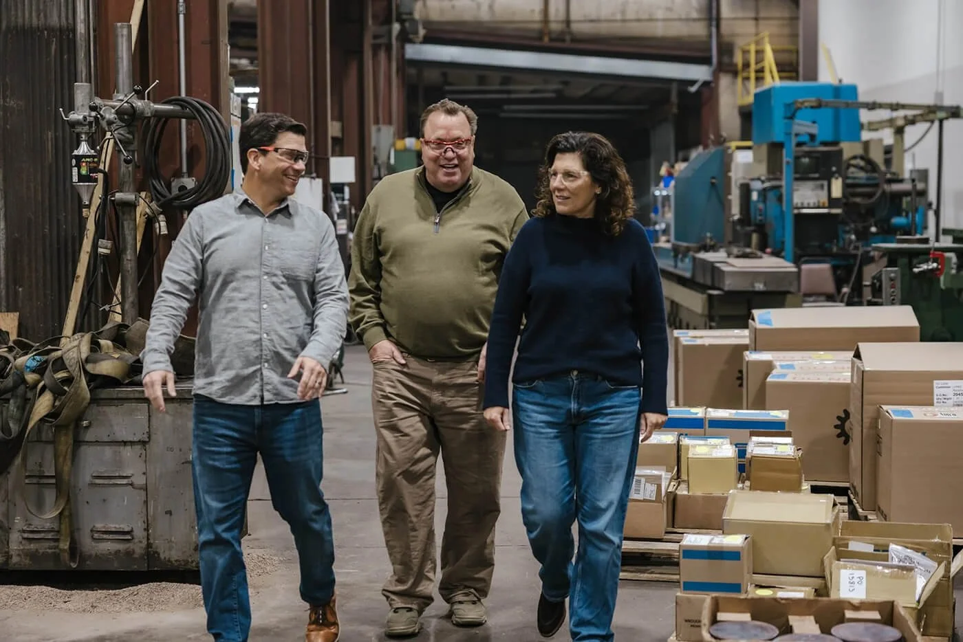 Wisconsin River Partners team members walking through a manufacturing facility and discussing operations.