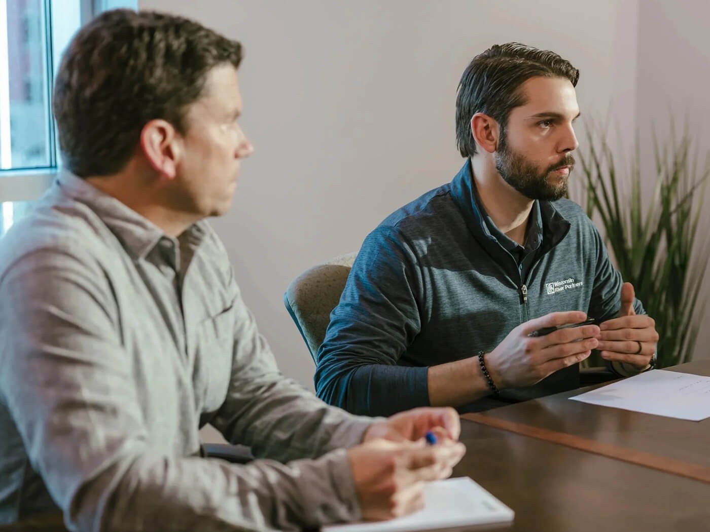 Team members discussing business goals together during a strategy meeting, reflecting aligned incentives.