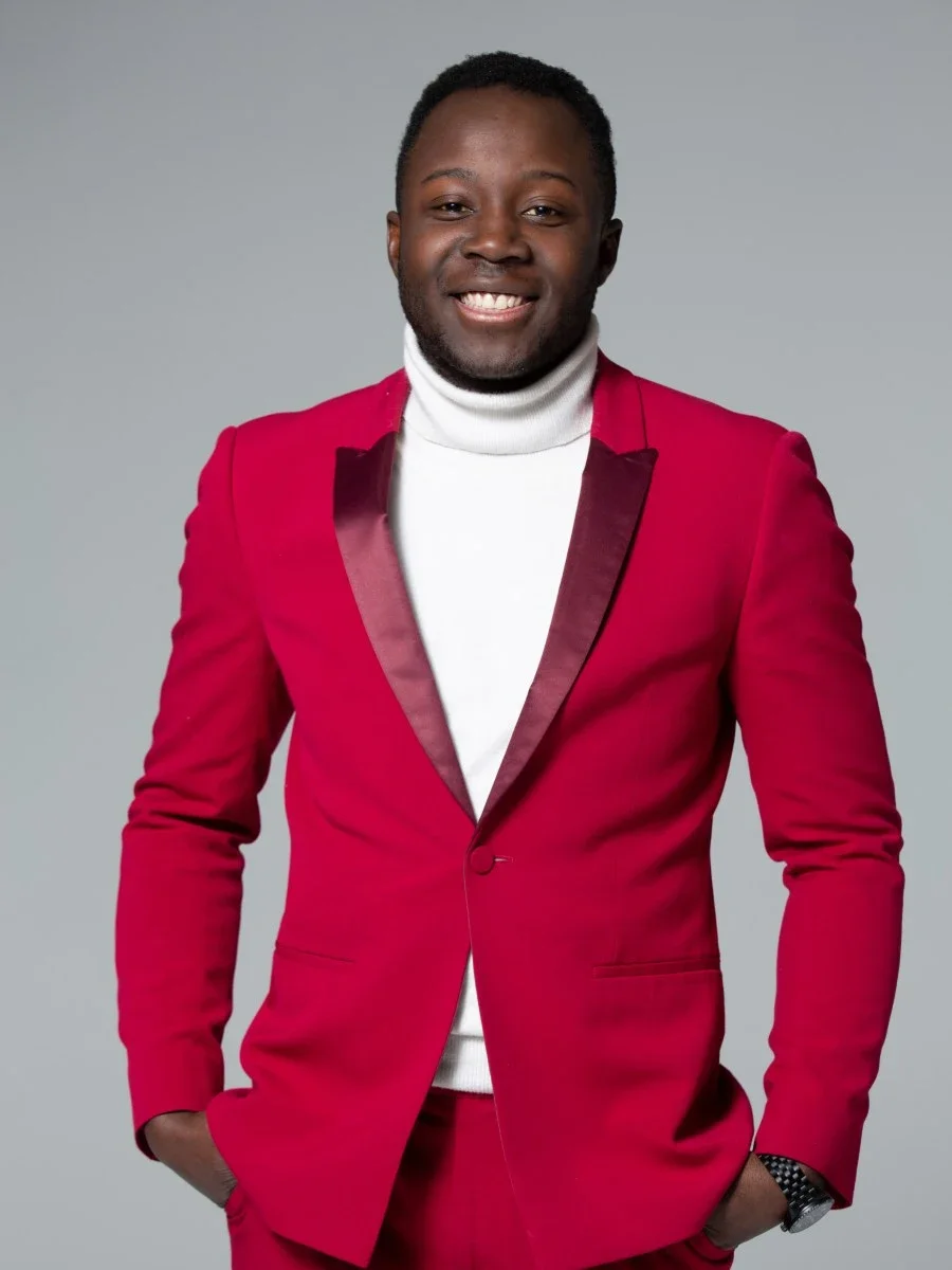 A picture of Samuel Vekeman, the Founder and CEO of TMG Belgium in a red suit