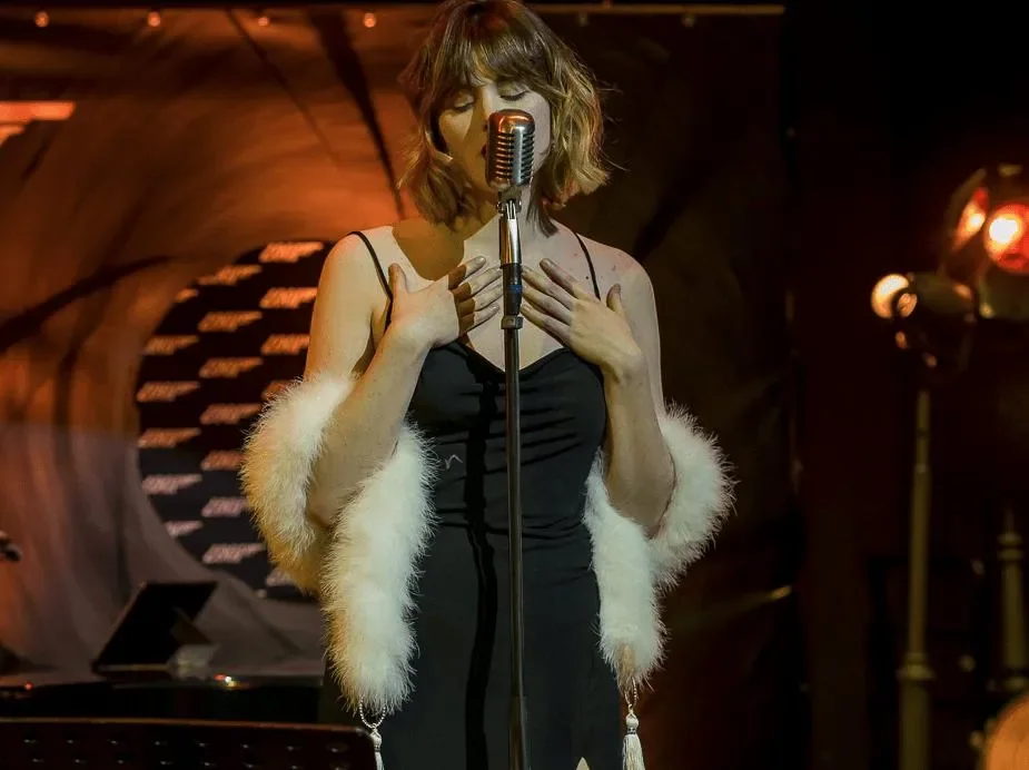 A blonde singer performing in one of the events organised by TMG Belgium