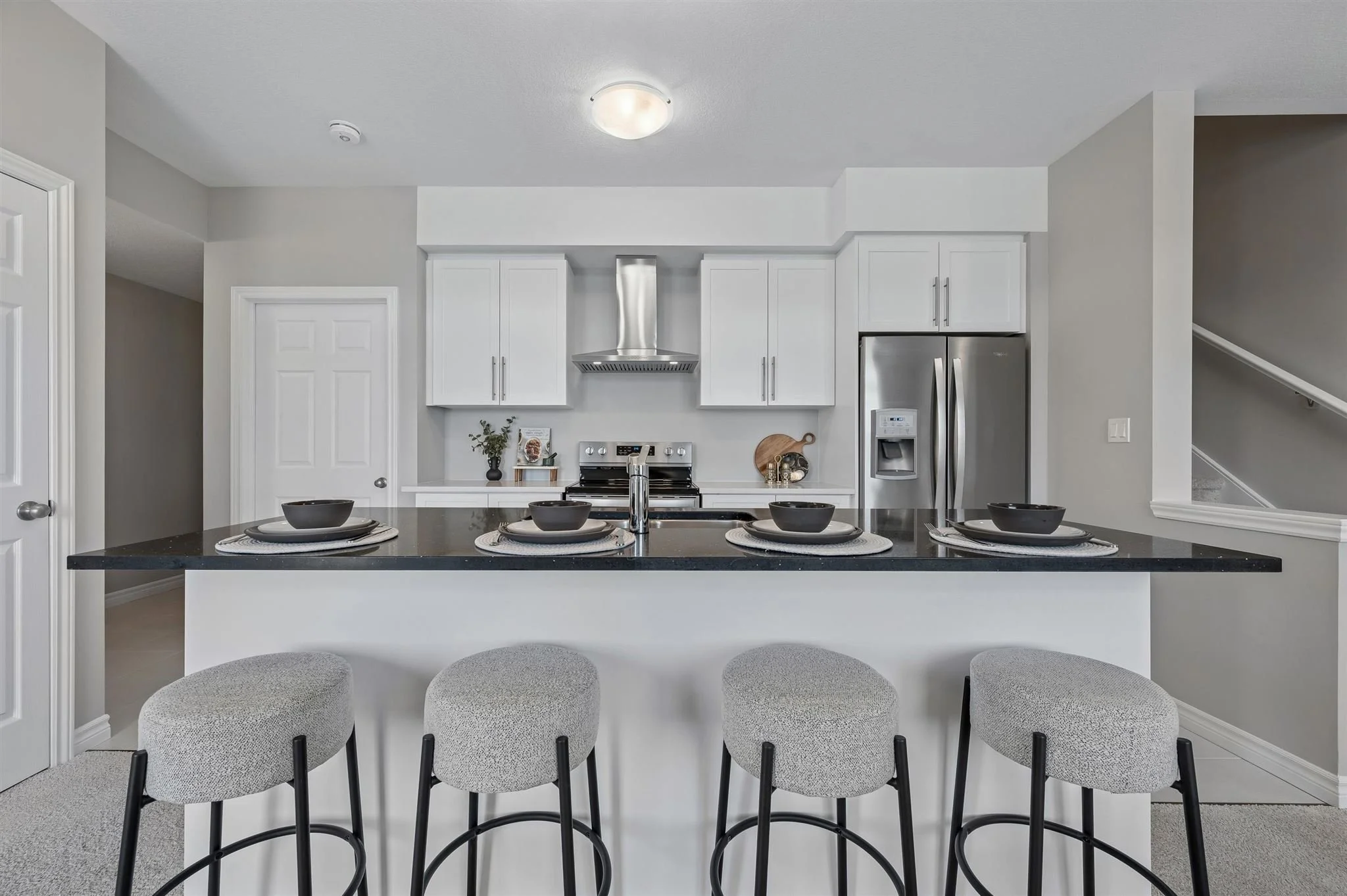 8 Oat Lane — Kitchen with black quartz island and seating for four