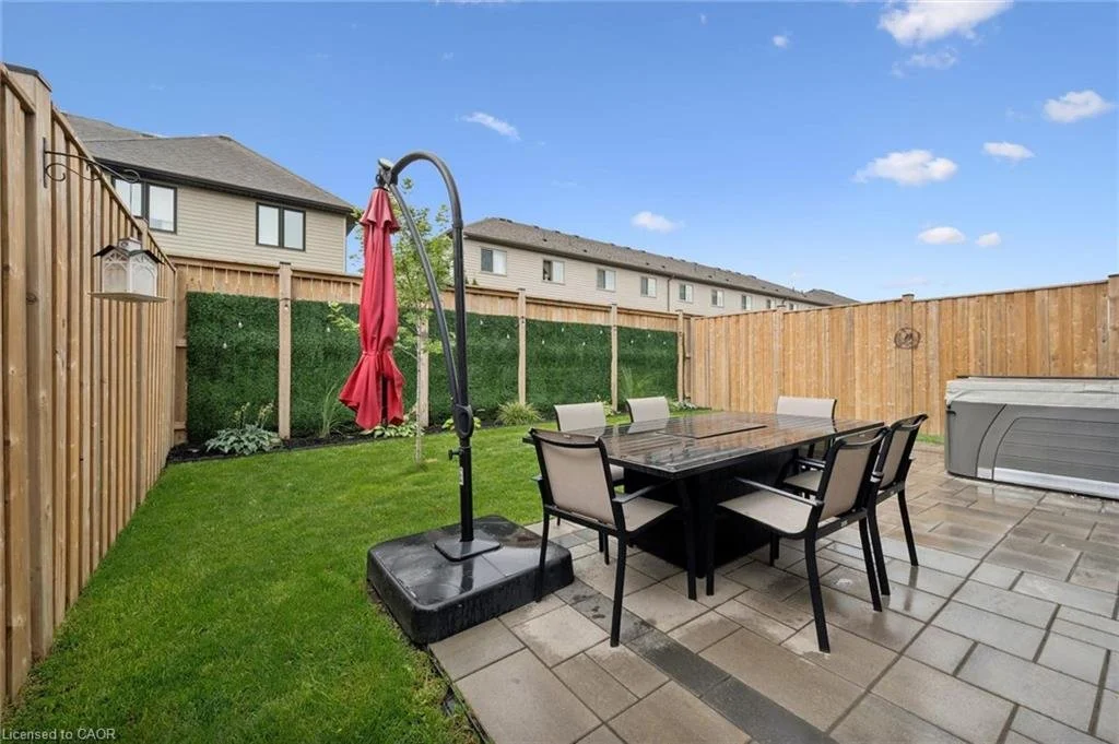 65 Miranda Path, Elmira — Fenced backyard with patio and hot tub