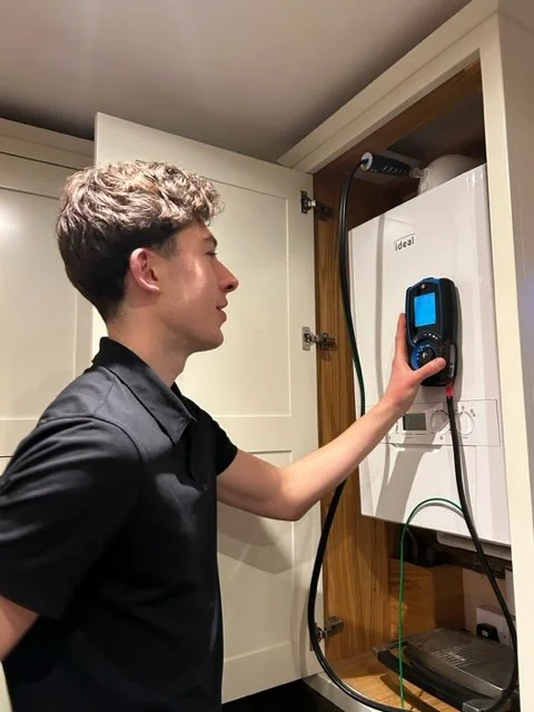 Man carrying out boiler service in a safe and efficient manner.