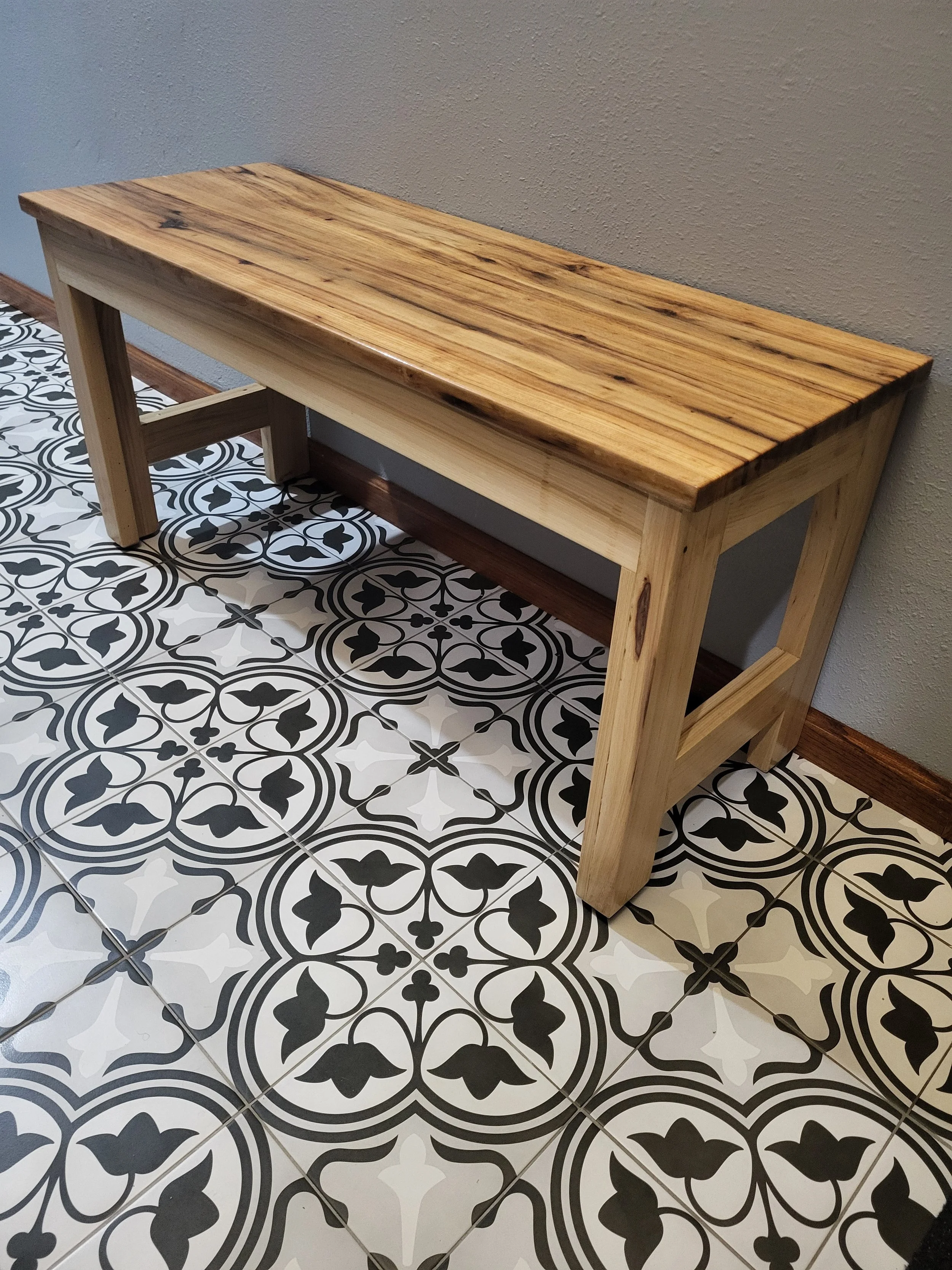 New shoe room flooring with custom solid hickory bench with epoxy finish.