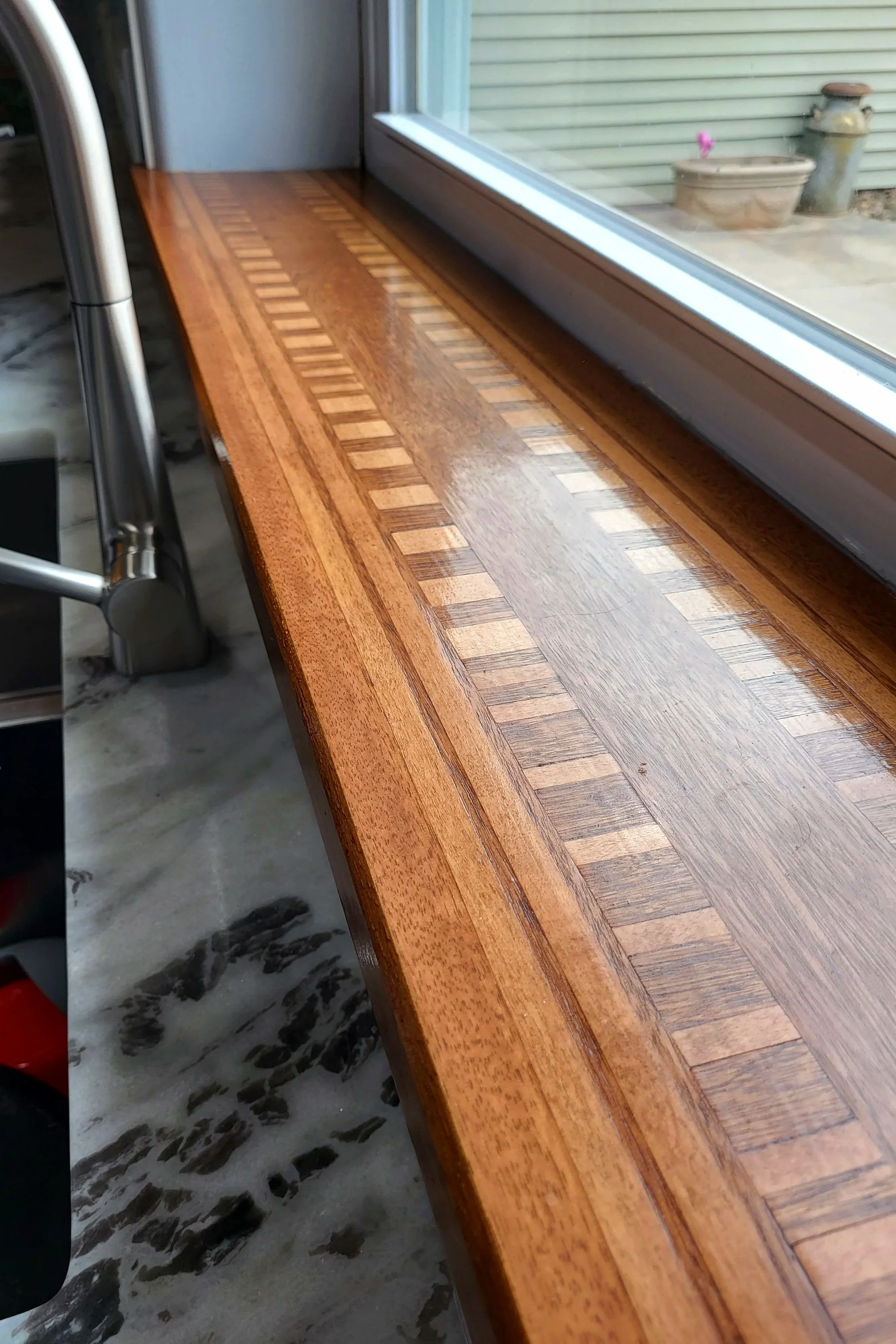 Custom wooden kitchen sill made from oak, maple and mahogany.