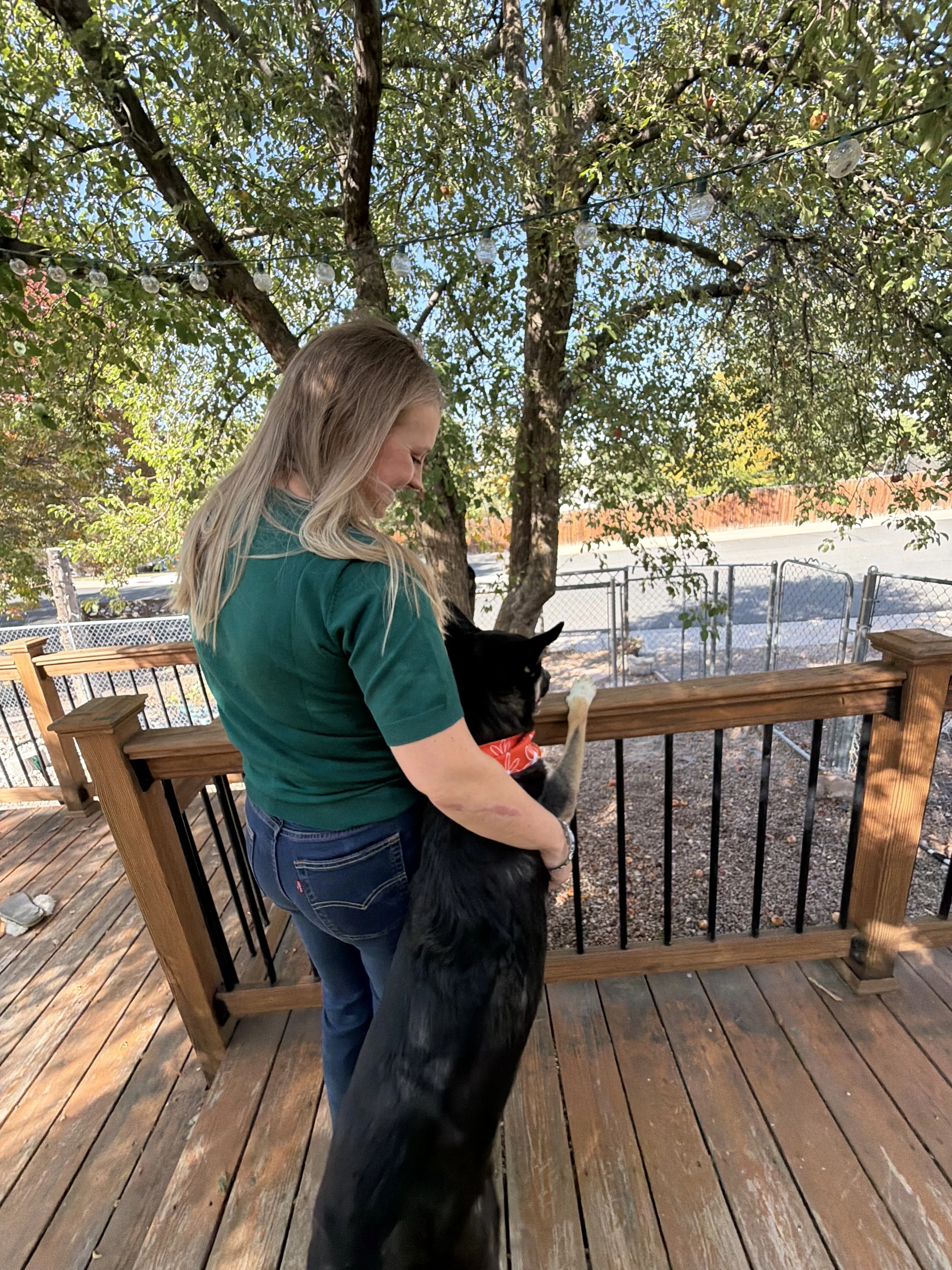An IFS Therapist and Holistic Therapist looking into the sunset with her dog in California