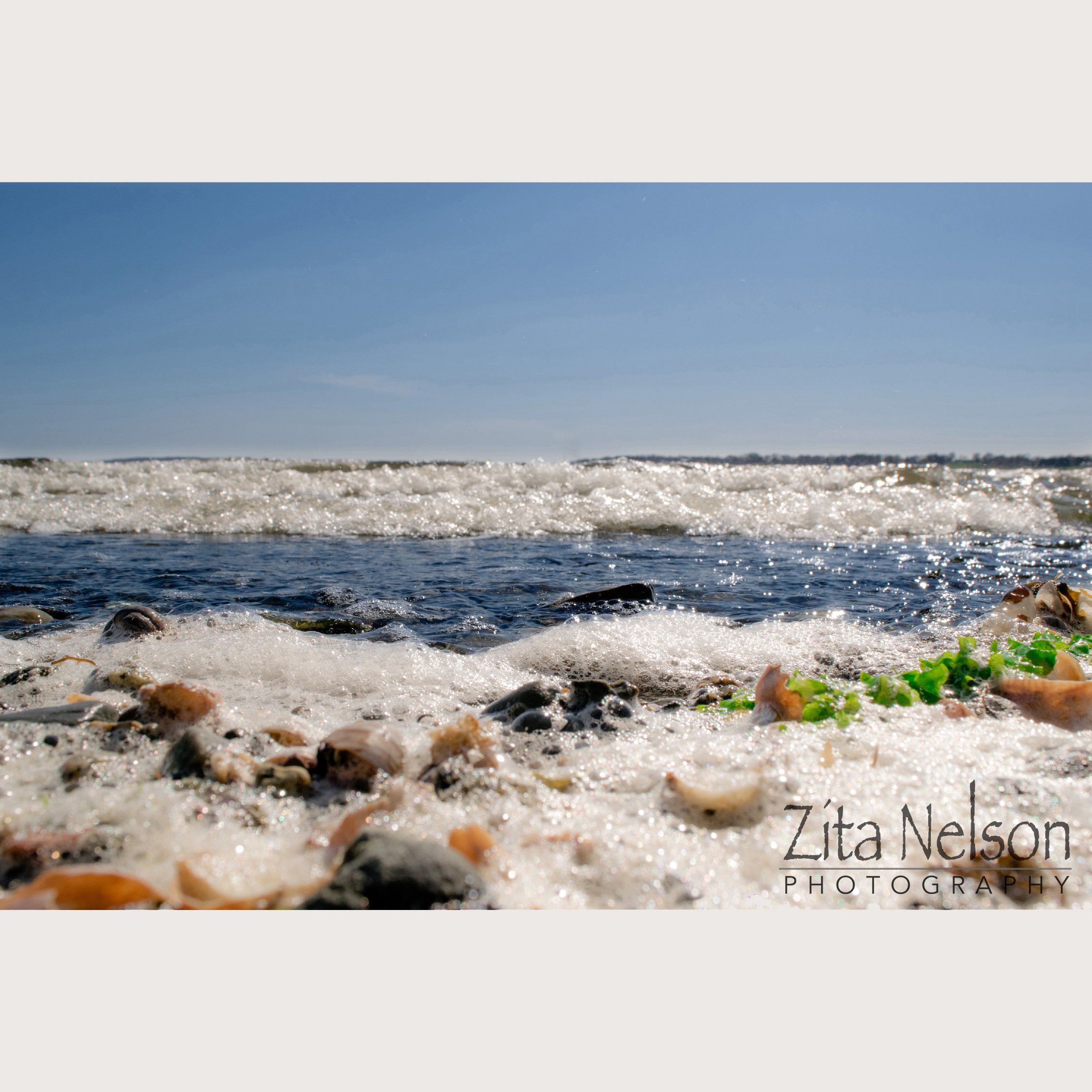 Calming Beach photo up close with rocks in front