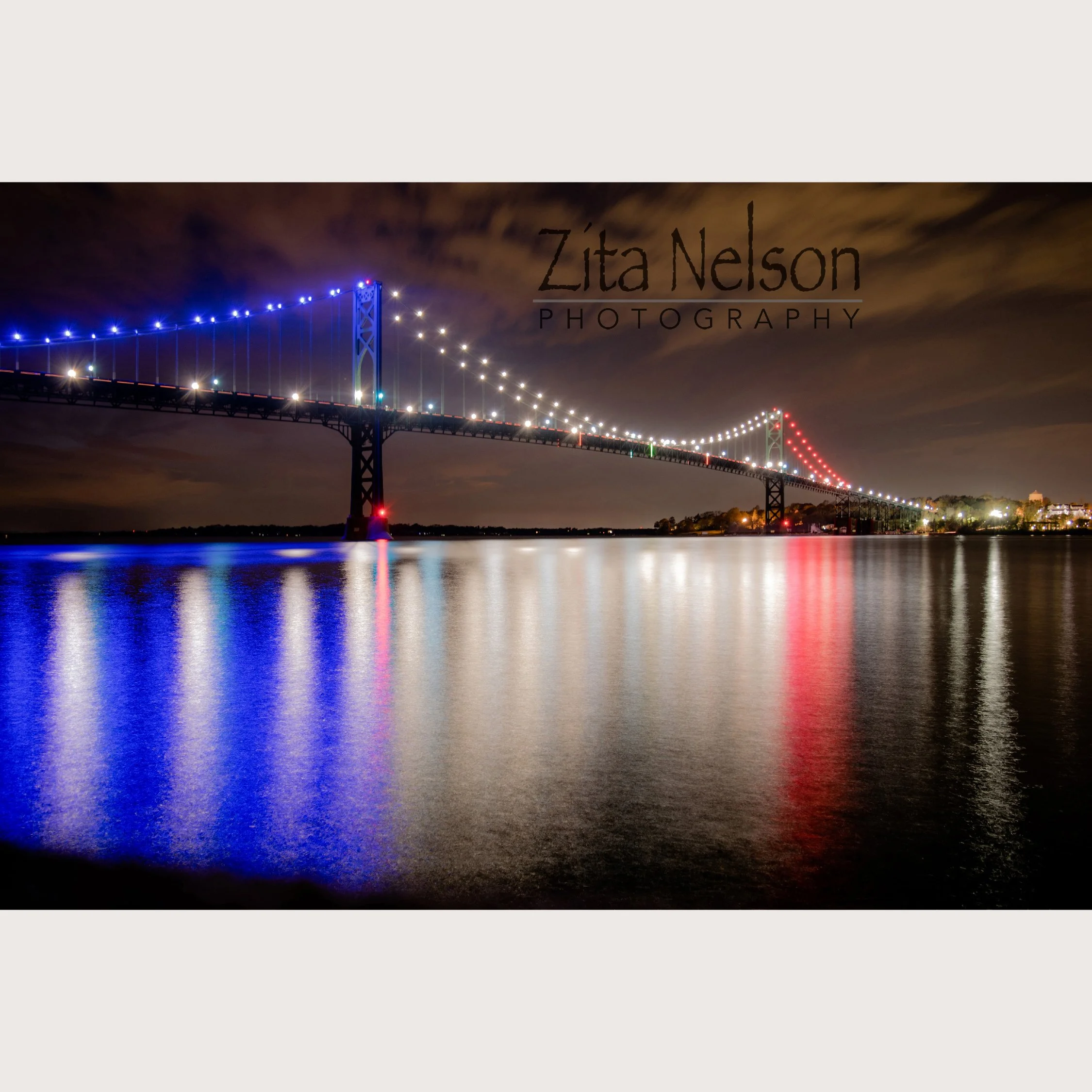 Photograph of Mount Hope Bridge at Dusk with Red White and Blue Lights