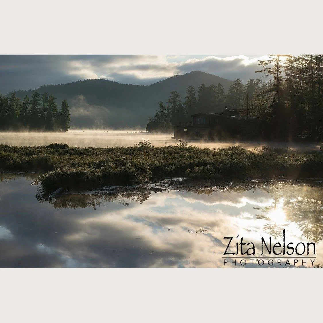 Photograph of morning dusk with mountain reflection in water at Lake Placid, NY