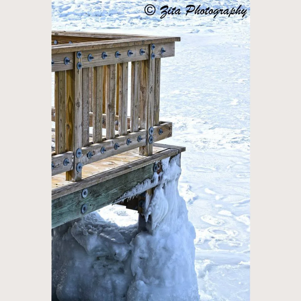Up close Photograph of Colt State Park dock in Bristol, RI frozen from a recent major storm