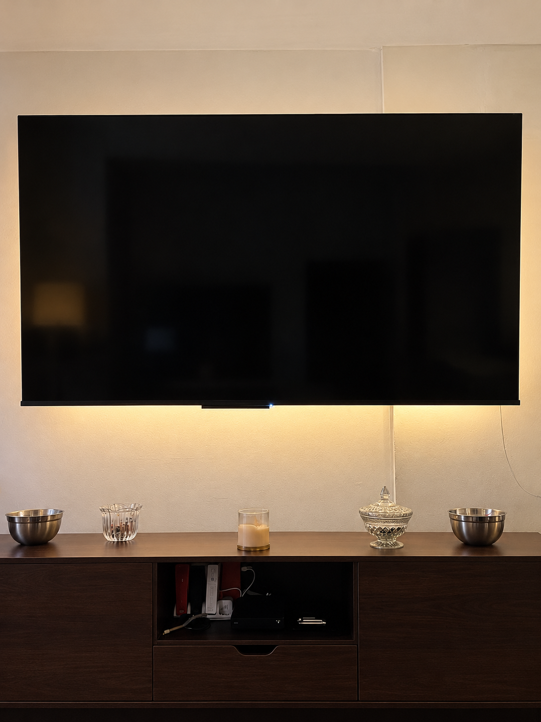 Polished wall-mounted TV with warm backlight.png