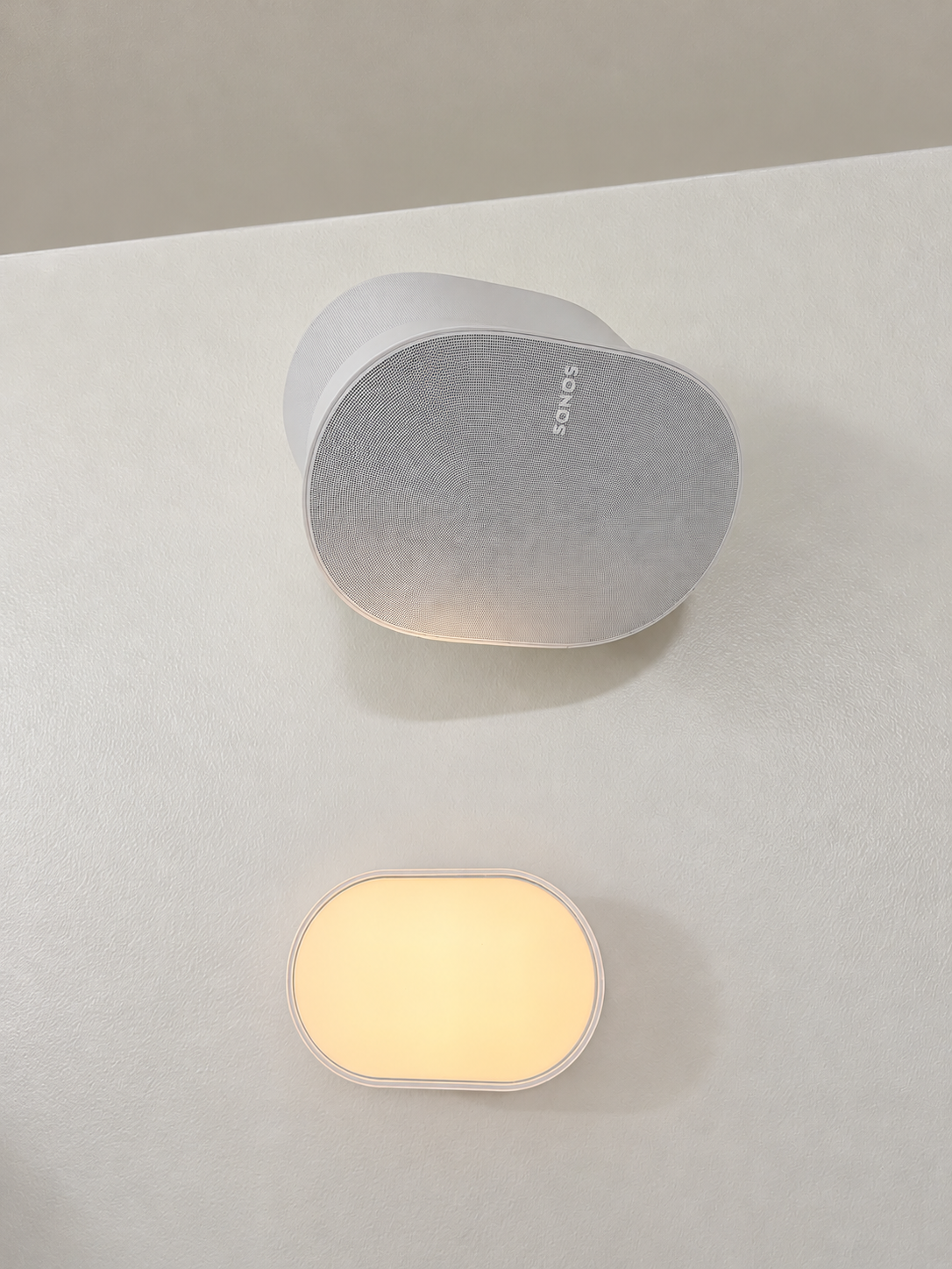 Minimalist Sonos Speaker and Warm Wall Light.png