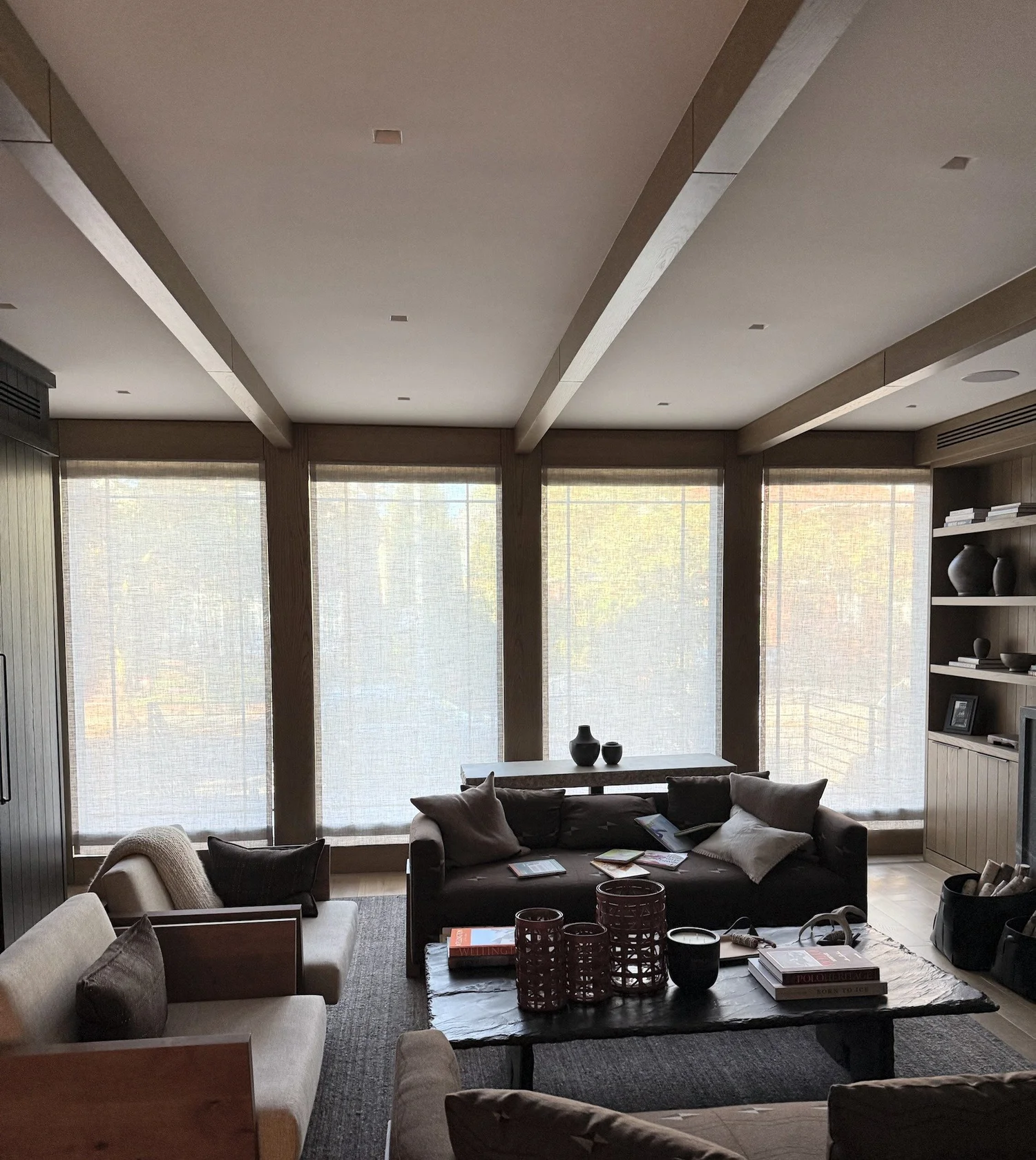Custom linen Roman shades on four floor-to-ceiling windows in a NYC living room