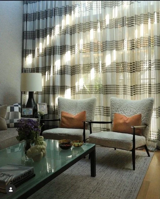 Cozy sitting room with bold striped floor-to-ceiling drapery and shearling lounge chairs NYC
