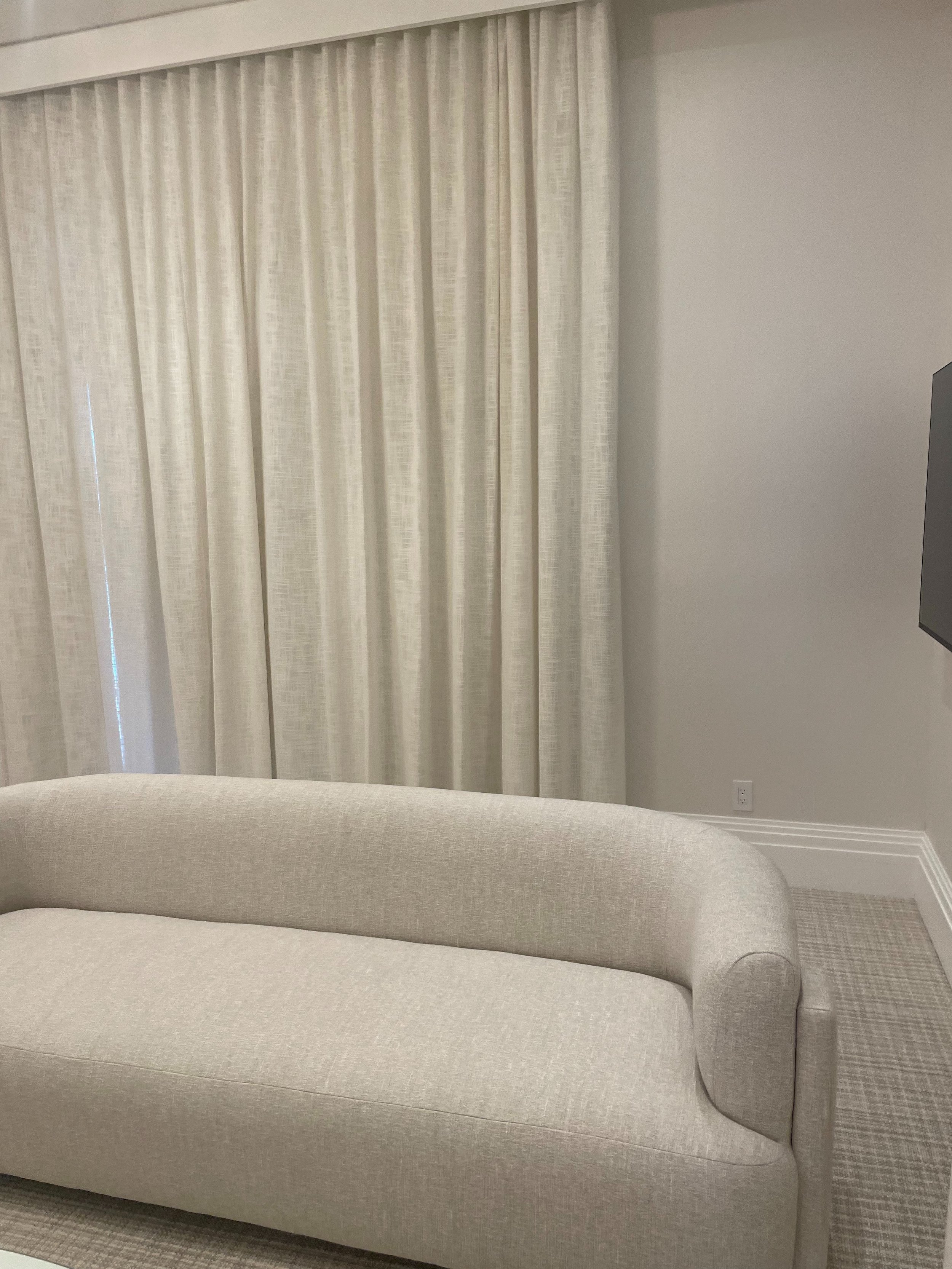 Luxury sitting room with custom upholstered sofa and ivory linen drapery by Rafael Interiors upholstery workroom NYC
