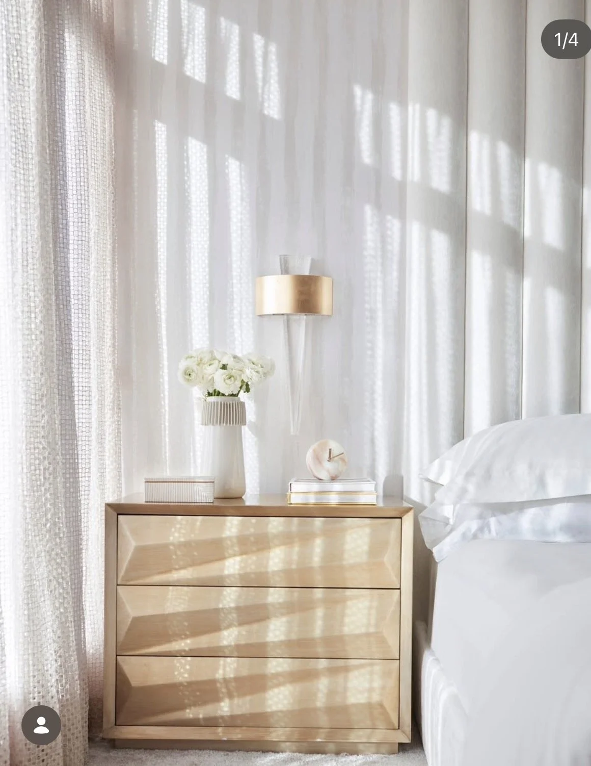 Luxurious bedroom closeup with gold geometric nightstand and sheer white drapery by Rafael Interiors