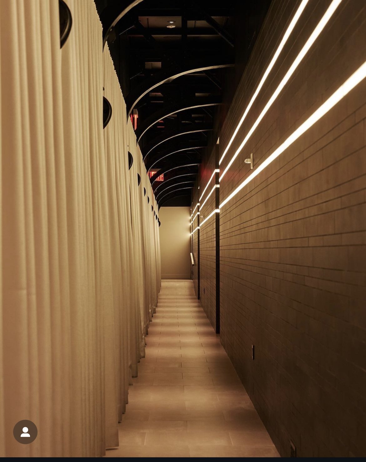 Ivory drapery on a curved ceiling track in the Casa Cipriani spa corridor, New York