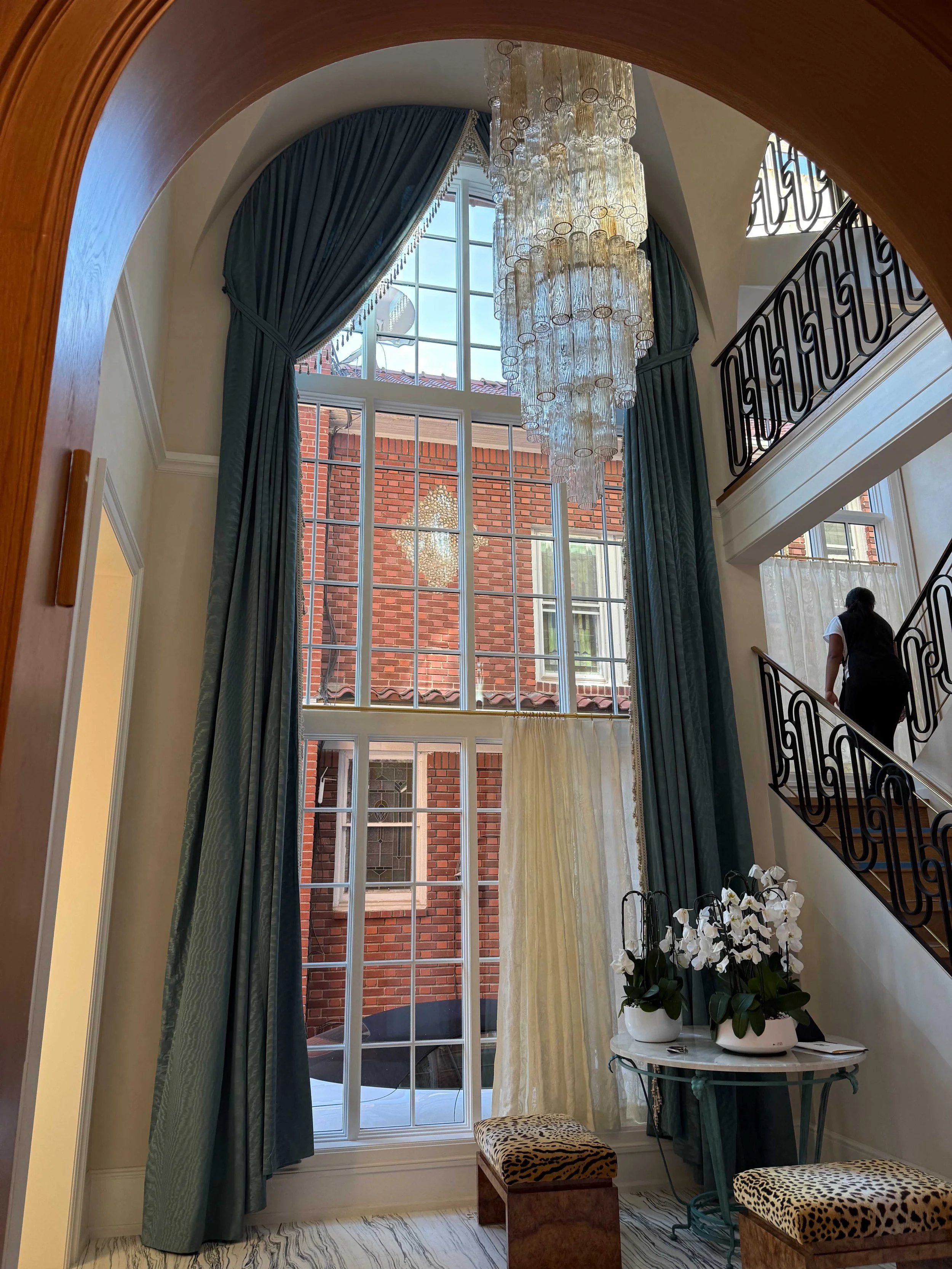 luxury-foyer-teal-drapery-murano-chandelier-arched-entryway-nyc.jpg
