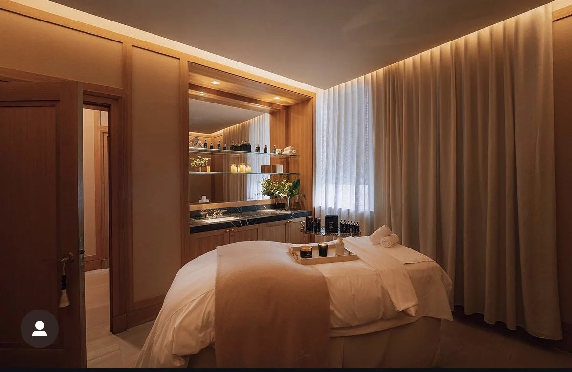 Luxury spa treatment room with warm wood paneling and beige sheer drapery, commercial window treatments NYC